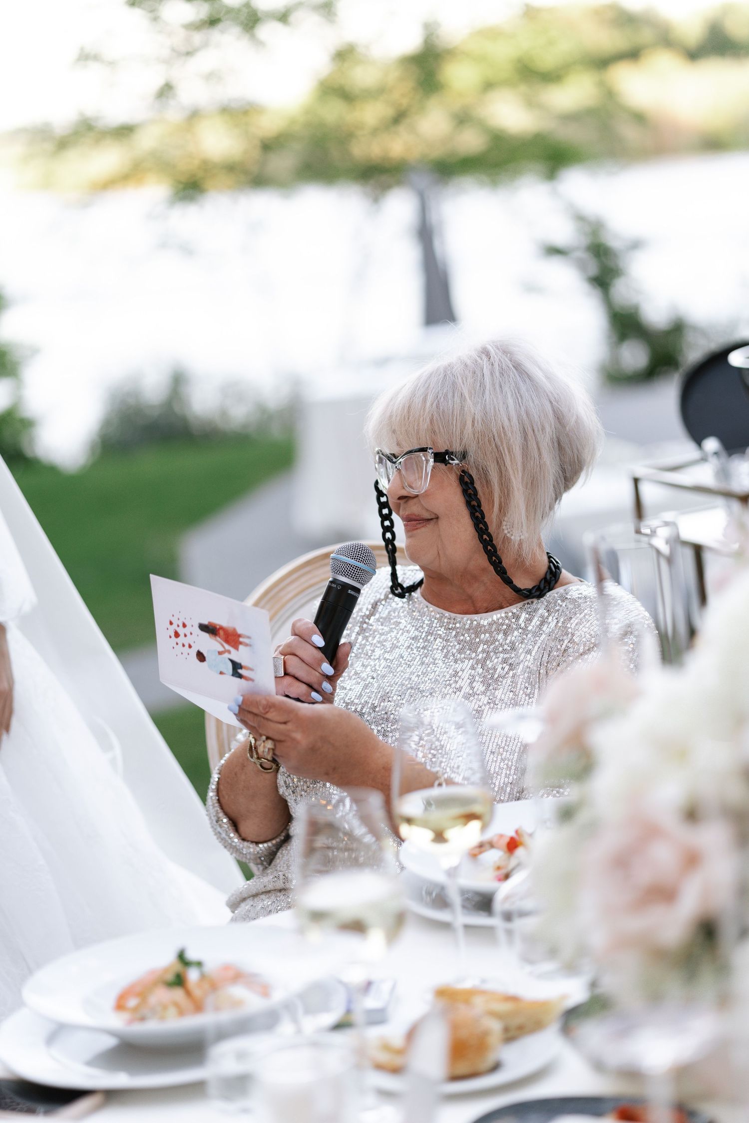 Elegant white table settings with crystal glassware at a formal wedding reception.