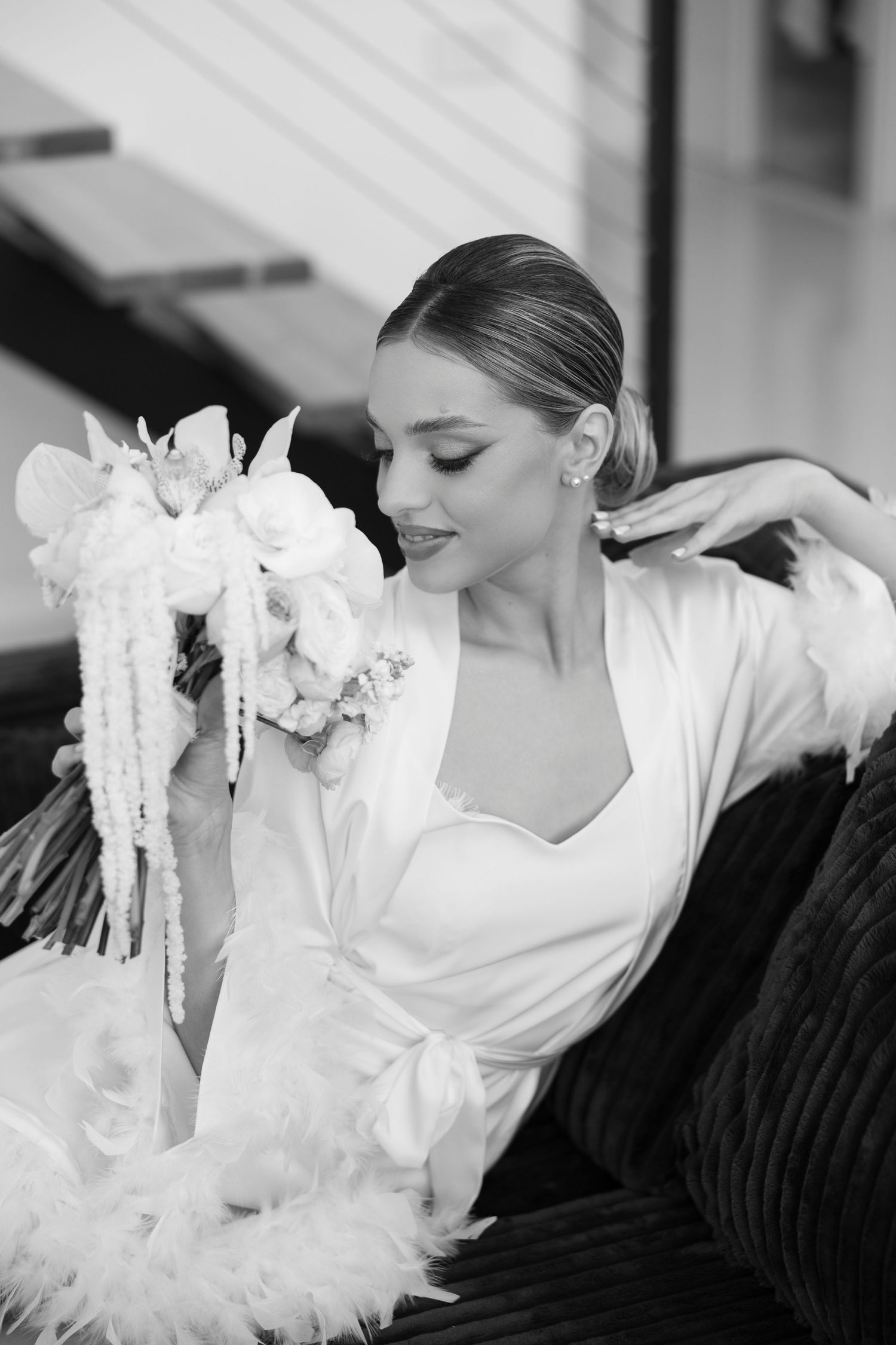 Series of artistic black and white photos showing delicate white flowers and bridal details.