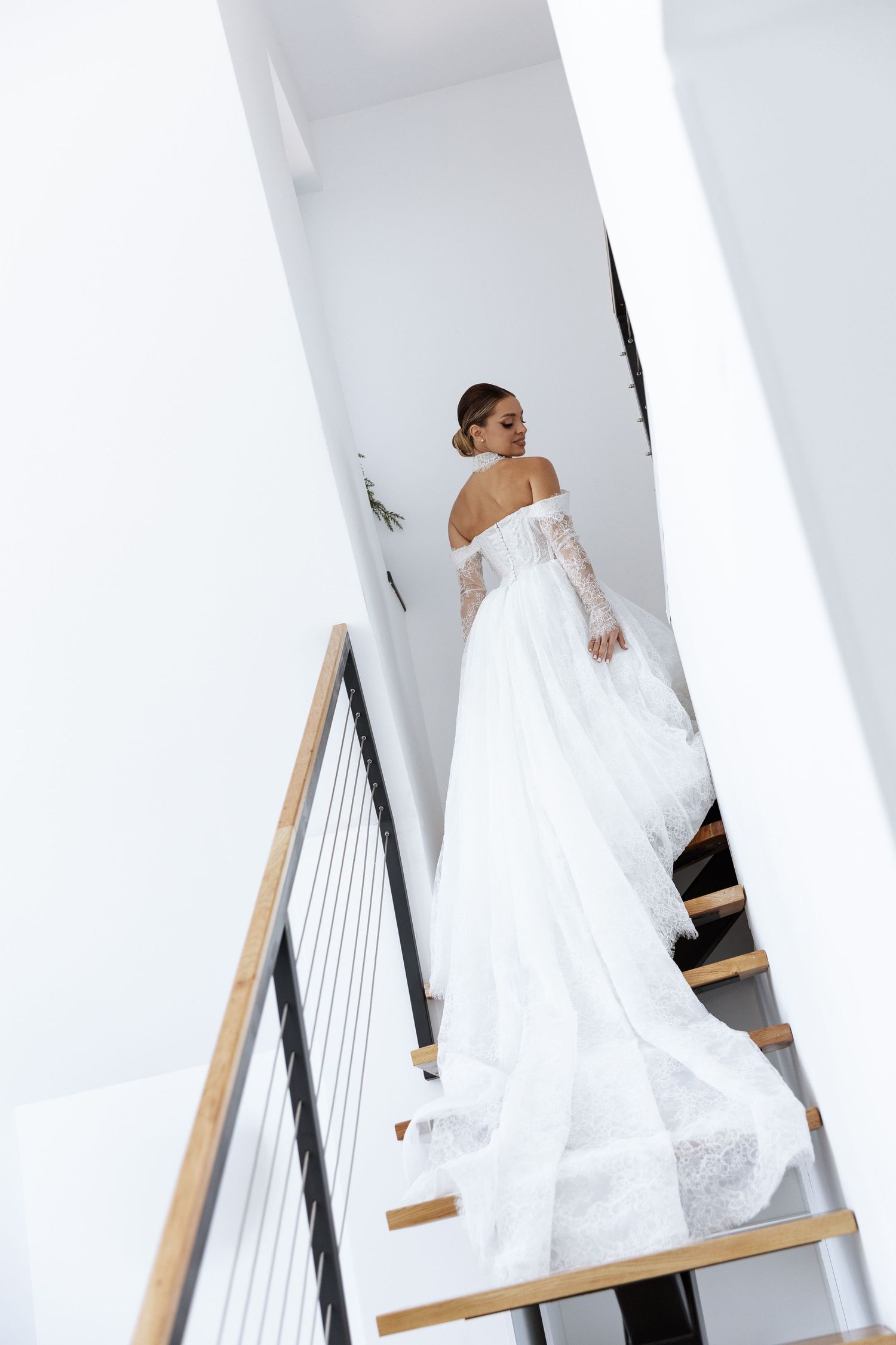 A sequence of photos showing a bride ascending a white staircase in a flowing wedding gown.