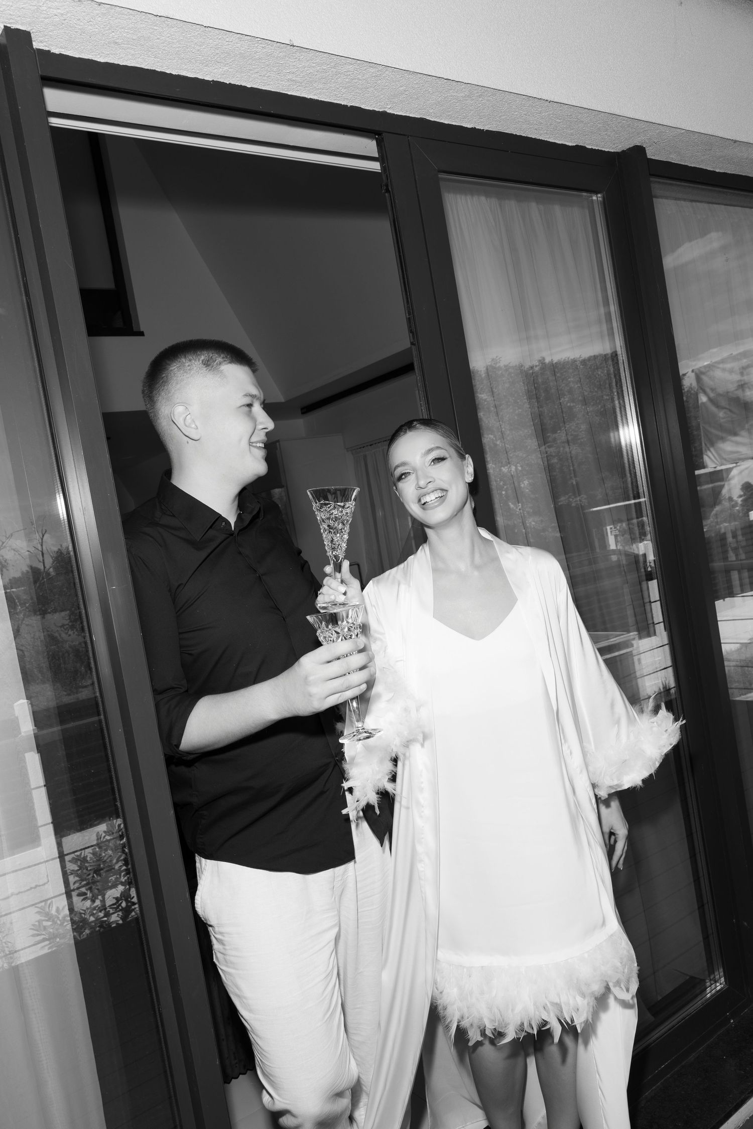 Black and white candid photos of people celebrating with drinks.