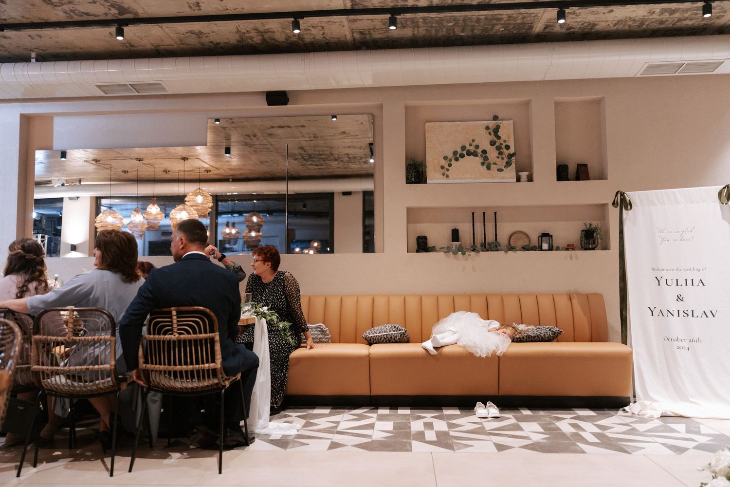 Modern restaurant interior with bench seating and industrial design elements at a wedding venue.