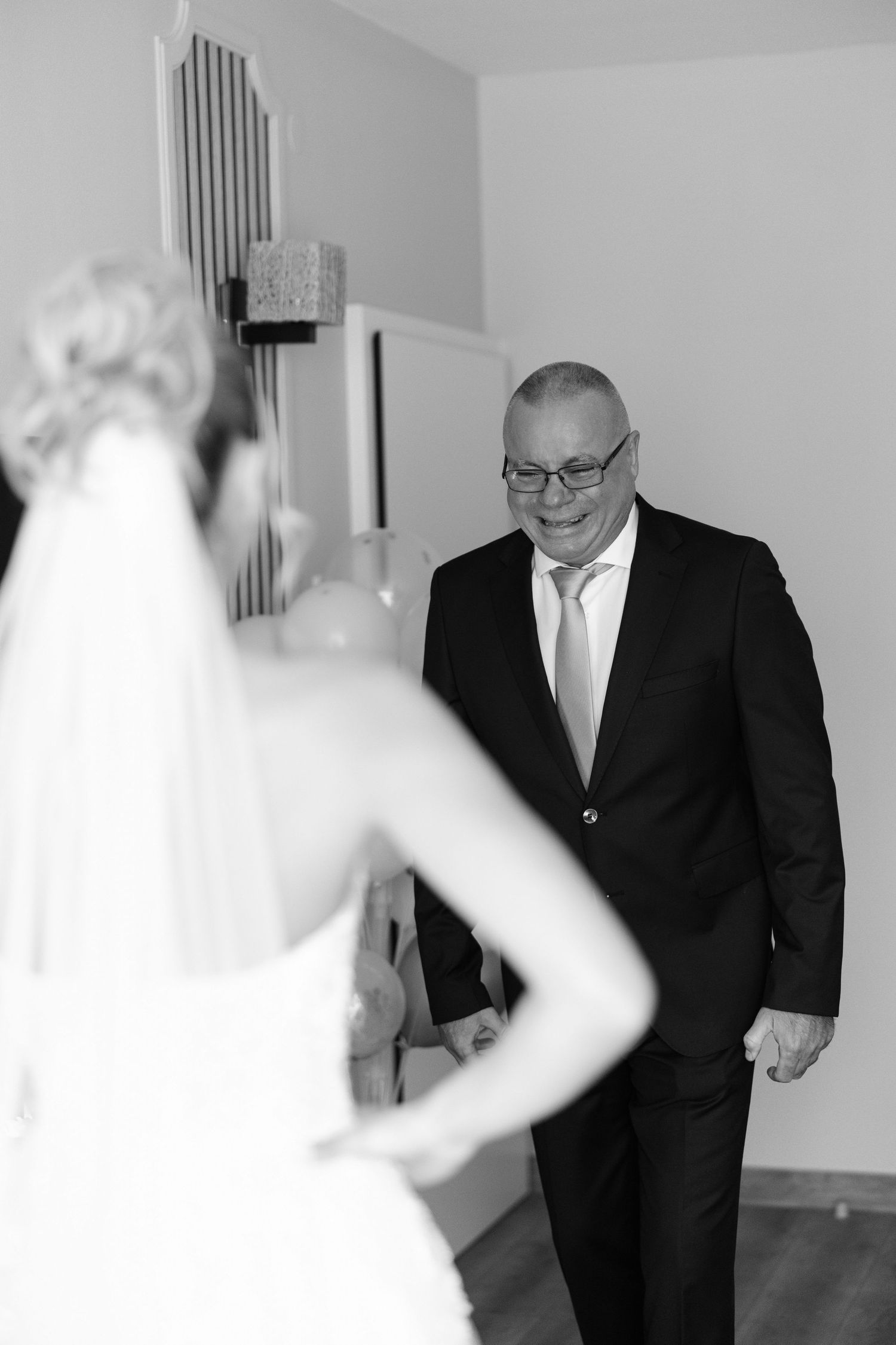 A series of black and white wedding photos showing emotional moments between a bride and family member before the ceremony.