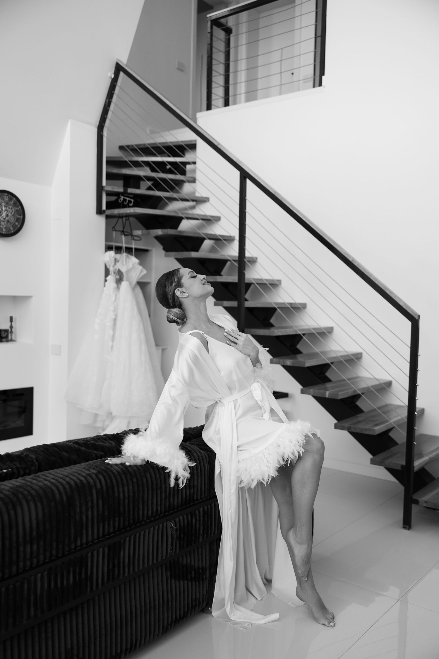 A series of black and white photos showing a ghostly white figure ascending a modern staircase with metal railings.