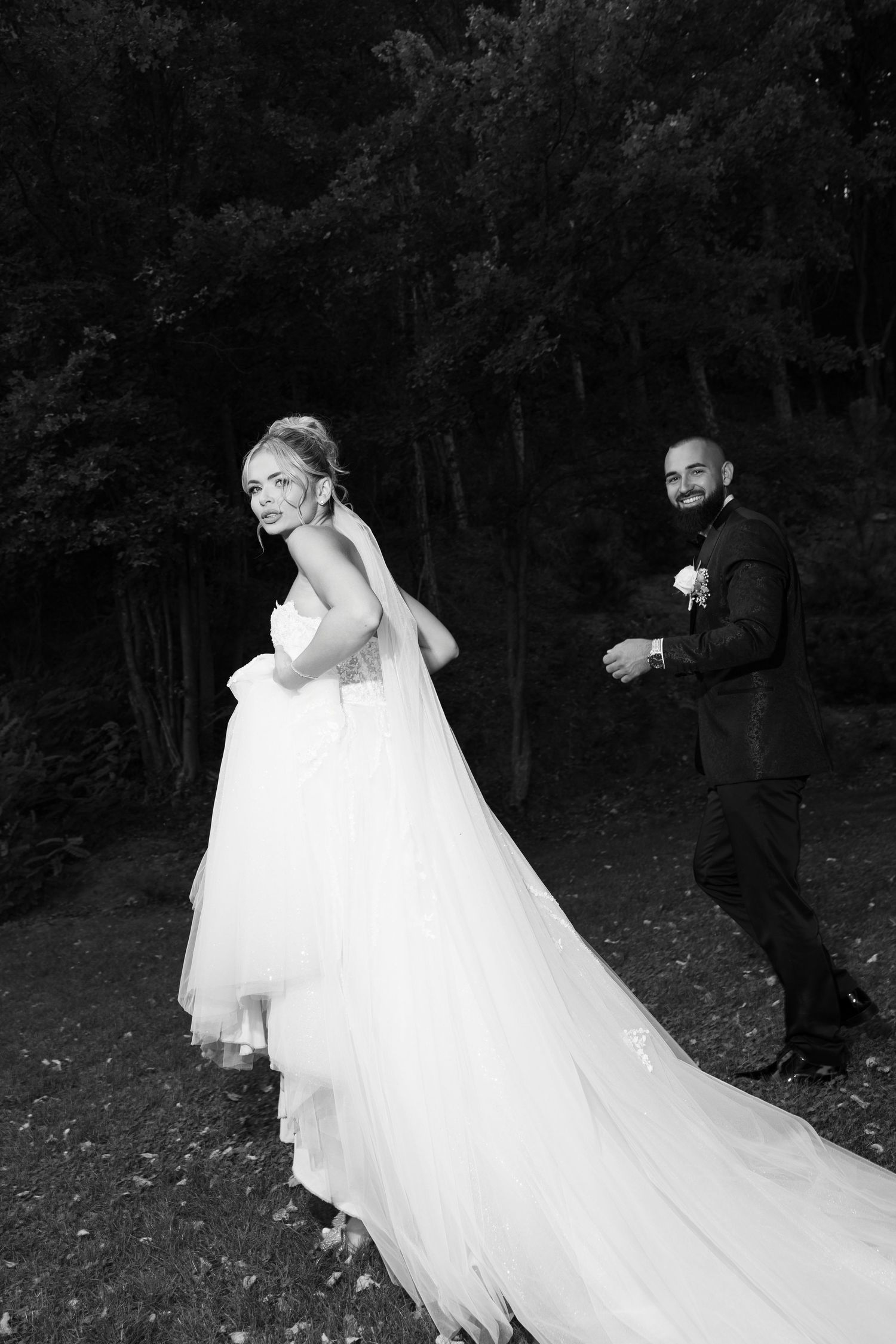 A romantic black and white wedding photo series showing a couple in a dramatic veil-blowing sequence outdoors.