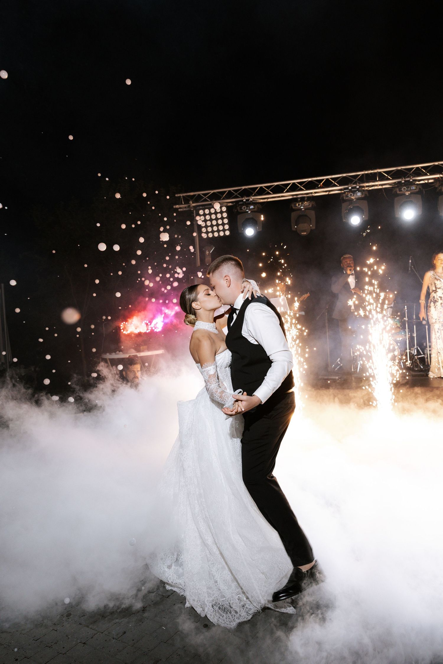 Couple dancing in fog with sparklers during their wedding first dance.