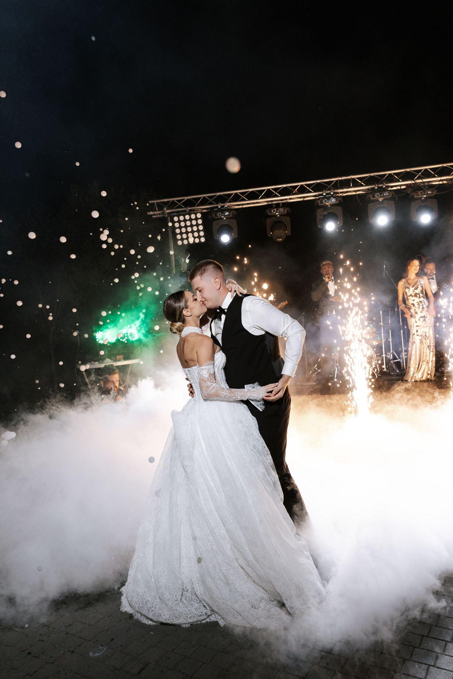 Dramatic first dance with fog effects and sparklers creating a magical atmosphere on the dance floor.