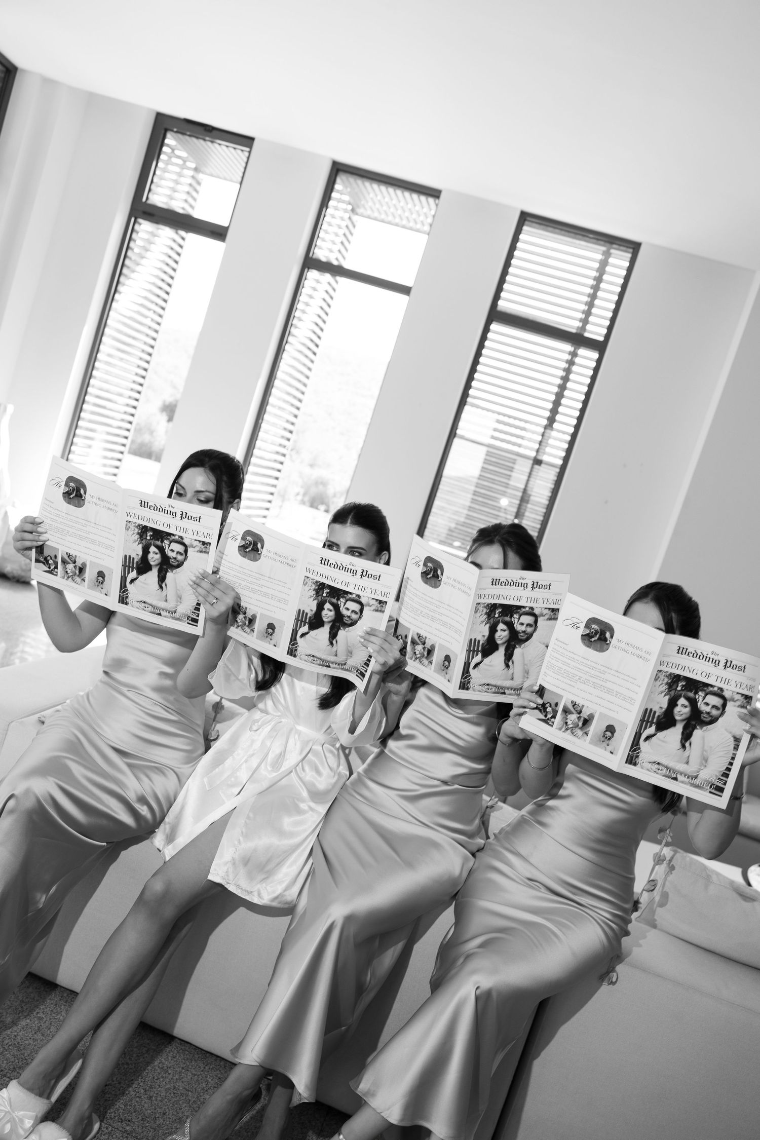 A sequence of four black and white photos showing nurses in white uniforms holding up papers in an office setting.