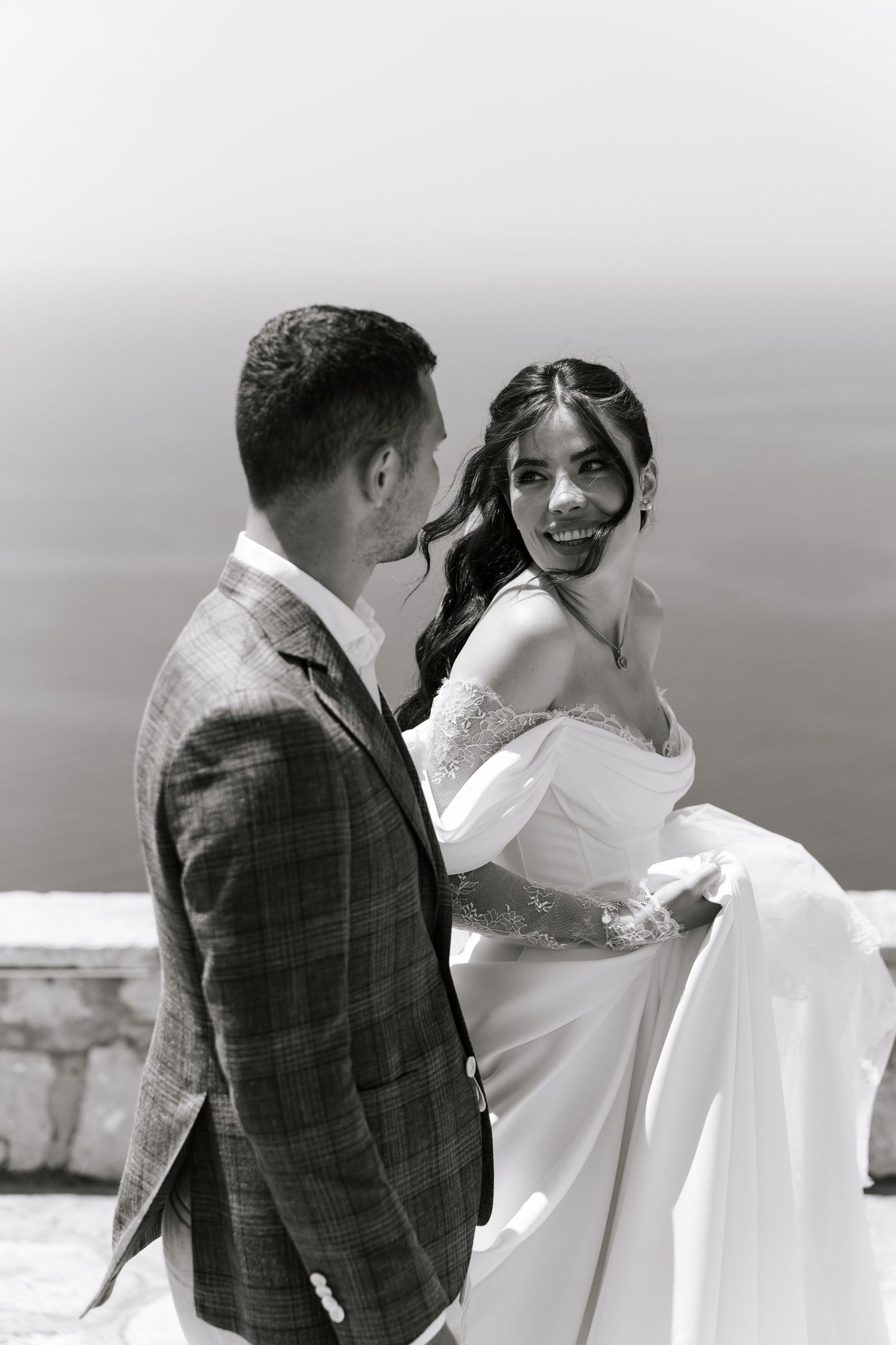 Black and white sequence of a romantic first look moment between newlyweds on a scenic overlook.