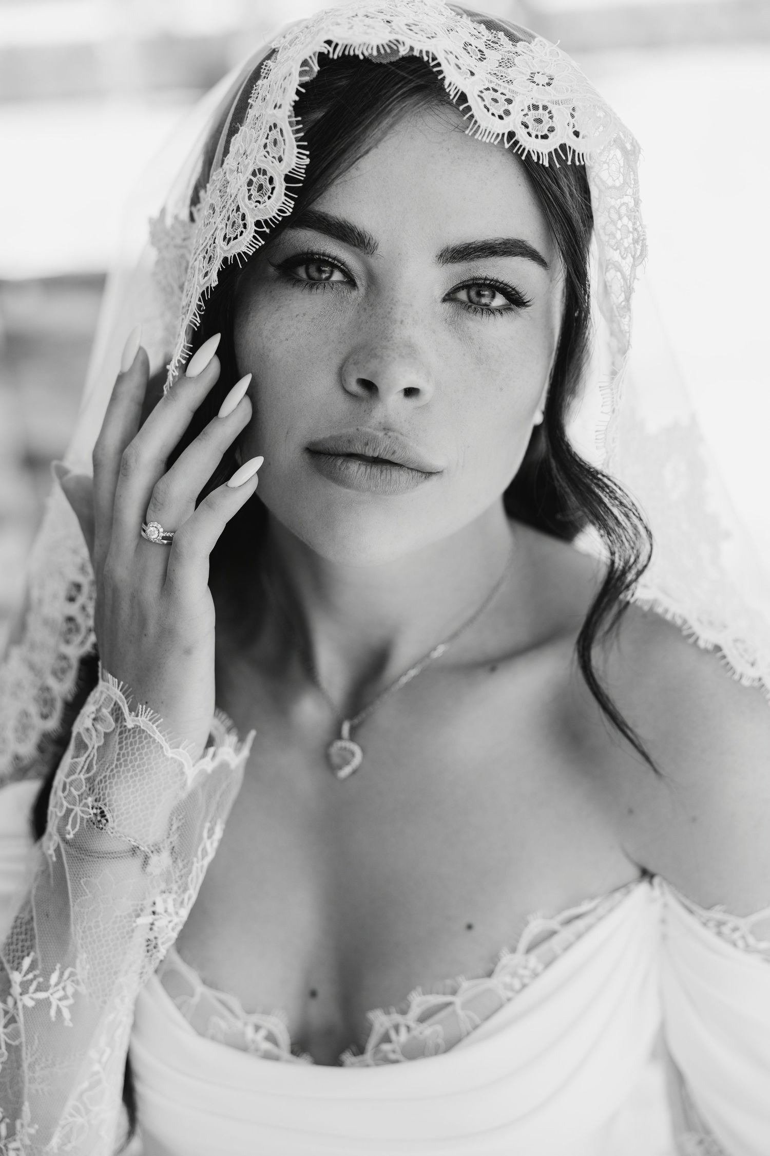 A black and white bridal portrait series showing delicate lace veil details and romantic close-up shots.