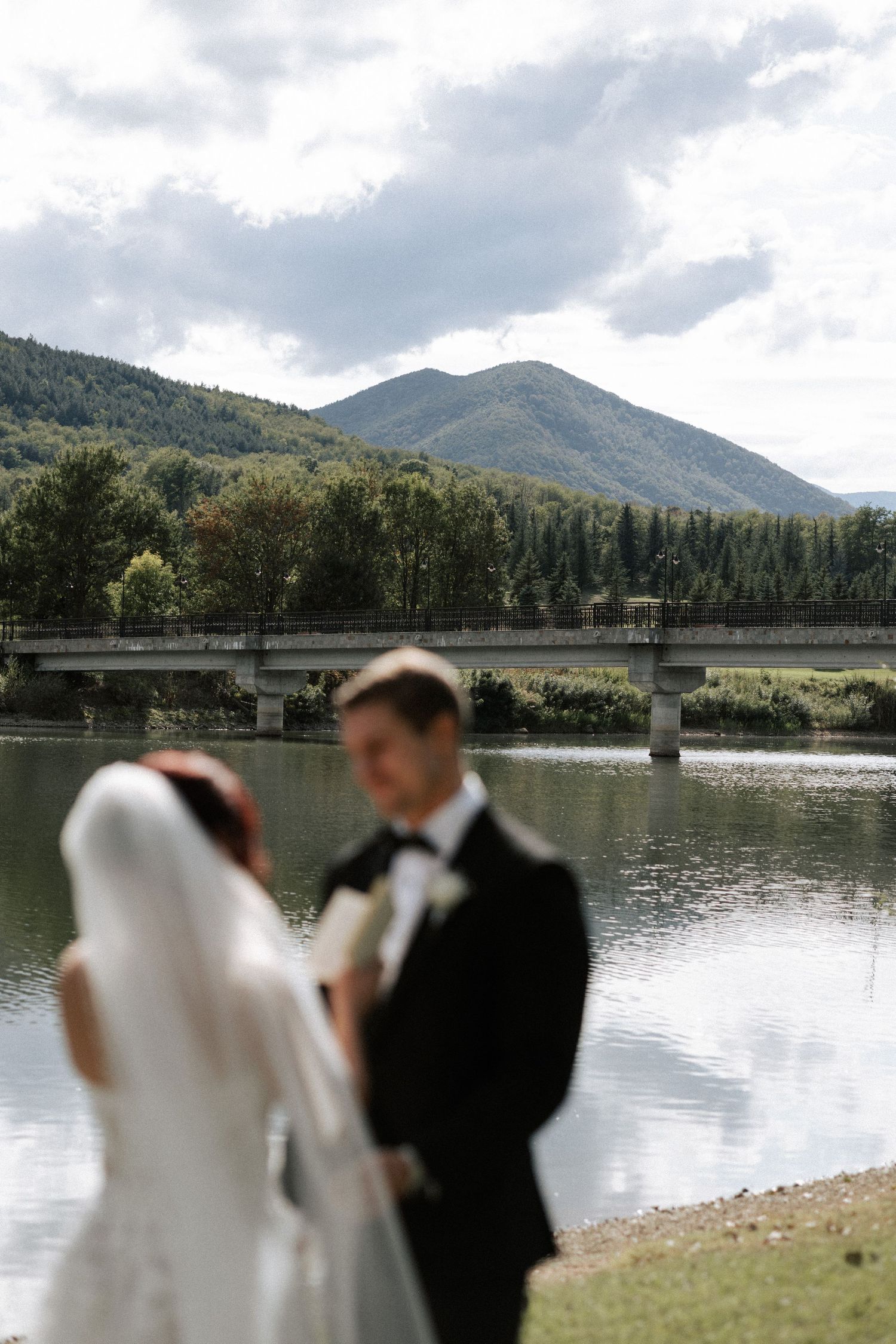 A scenic mountain lake provides the perfect backdrop for an outdoor wedding ceremony.