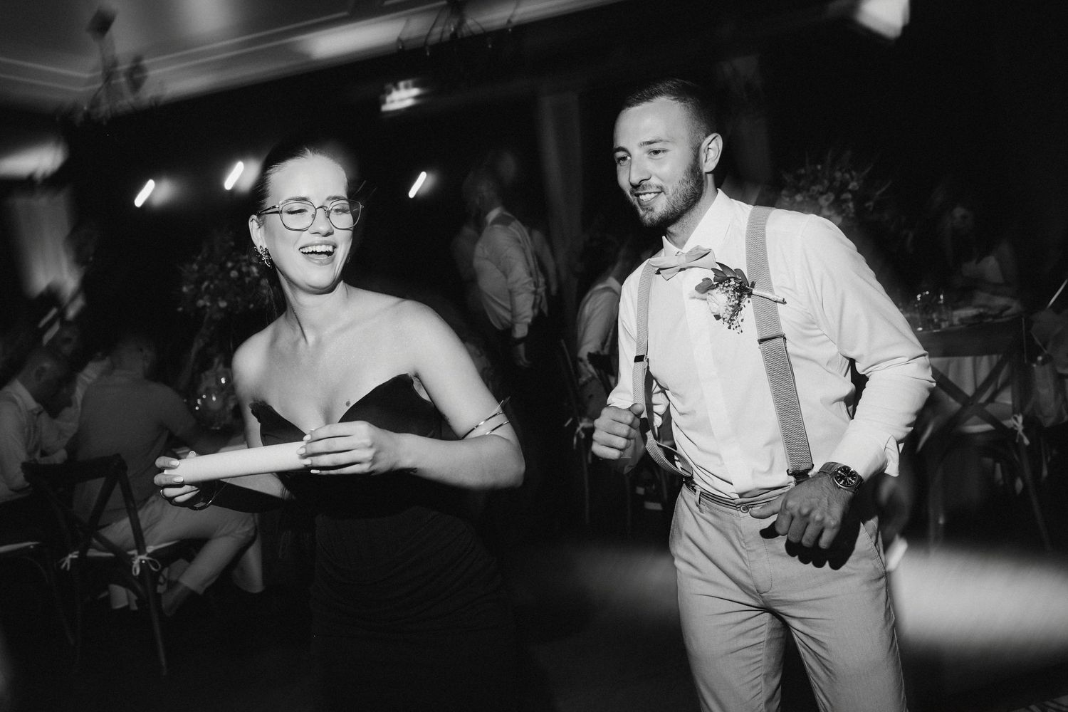 A black and white photo collage shows candid moments from a wedding reception celebration.