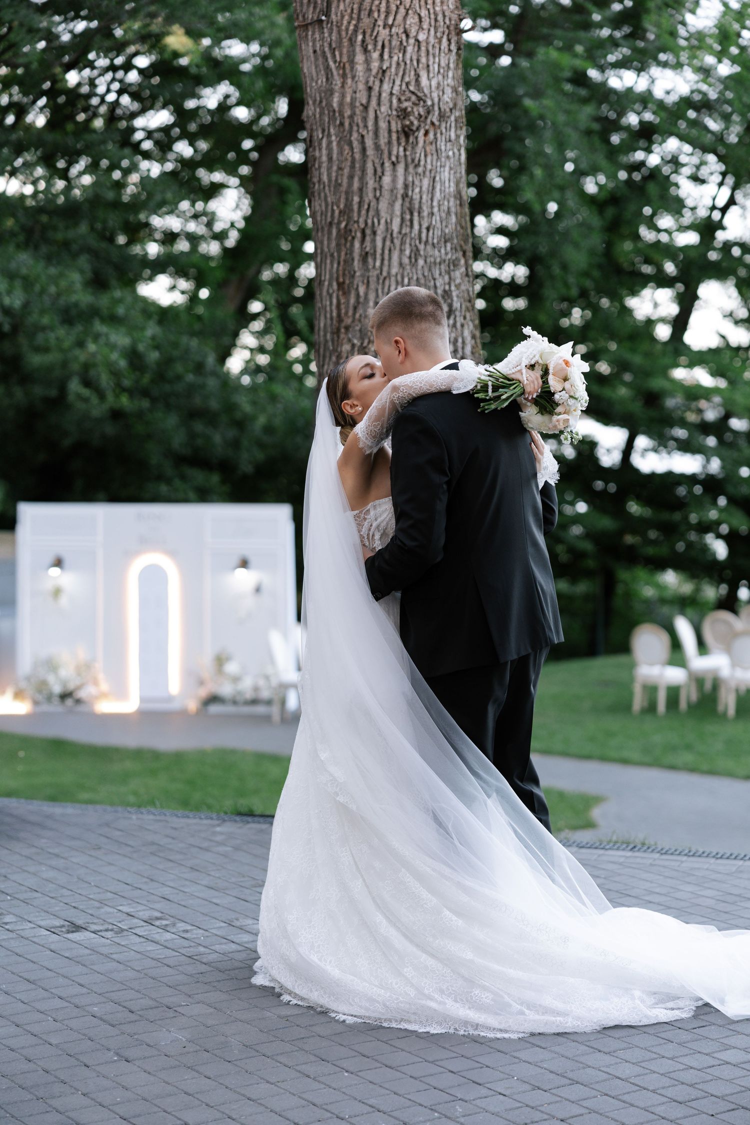 Romantic wedding couple dancing outdoors with flowing white wedding dress.