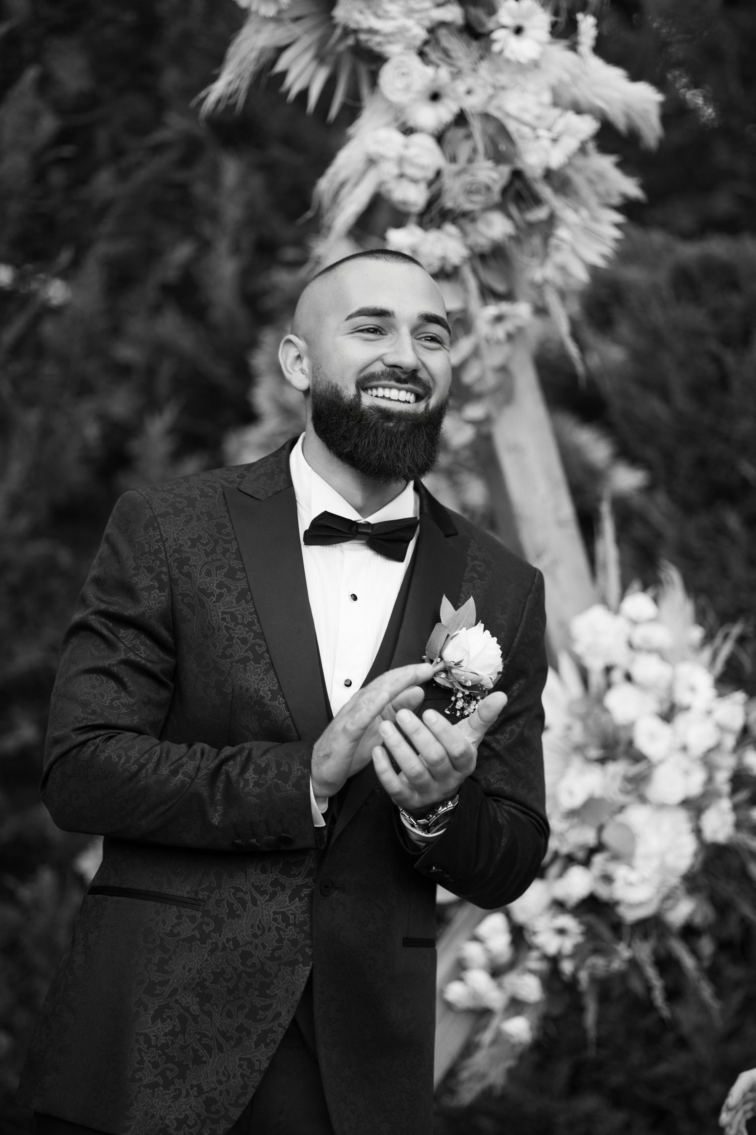 A black and white photo series showing joyful reactions and laughter in formal attire with floral decorations.