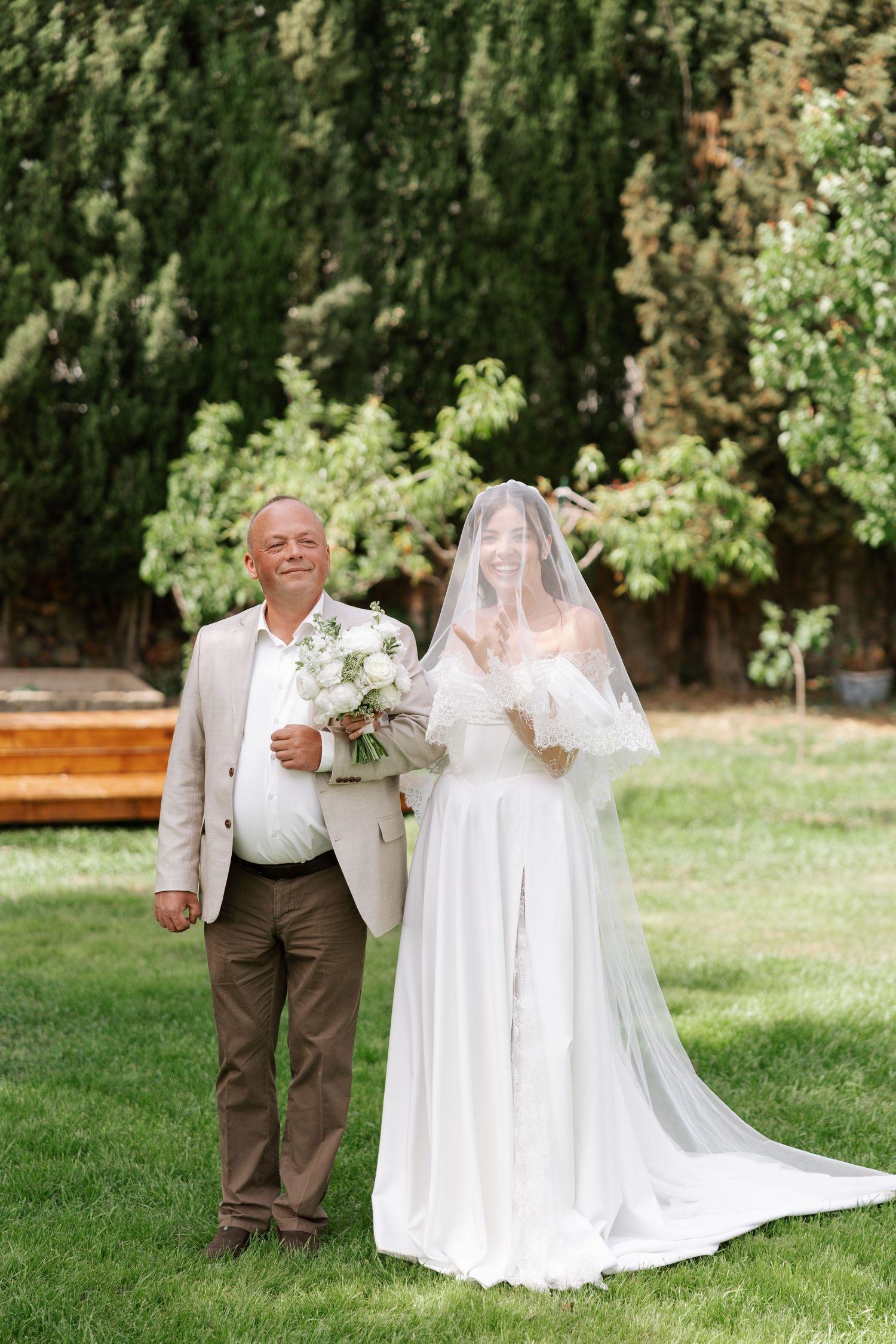 A couple shares a sweet first look moment in a garden setting during their wedding celebration.