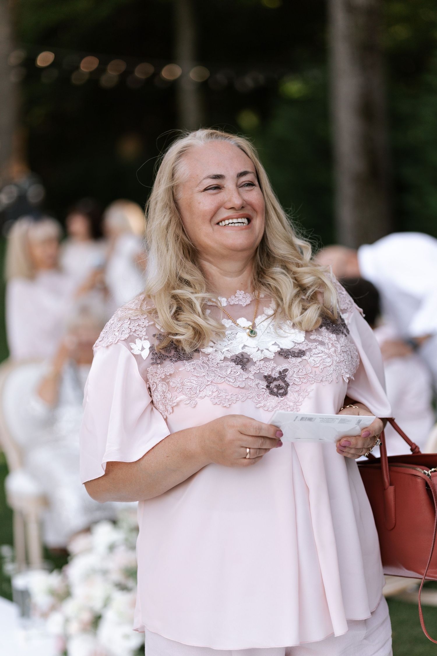 Wedding guests in light colored attire enjoying a celebration.