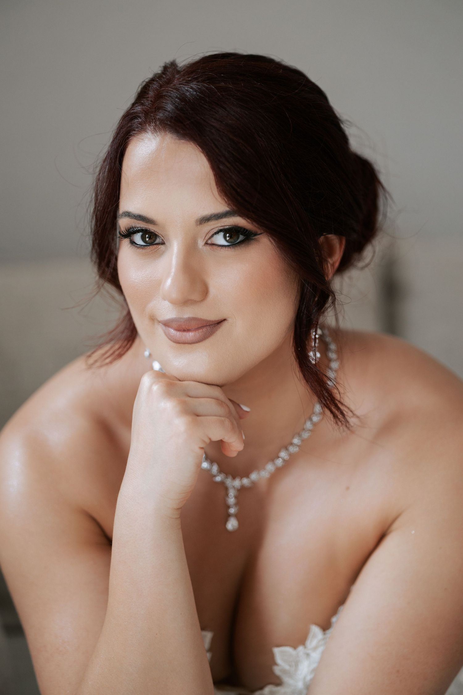 Bridal portrait featuring elegant jewelry and soft makeup.
