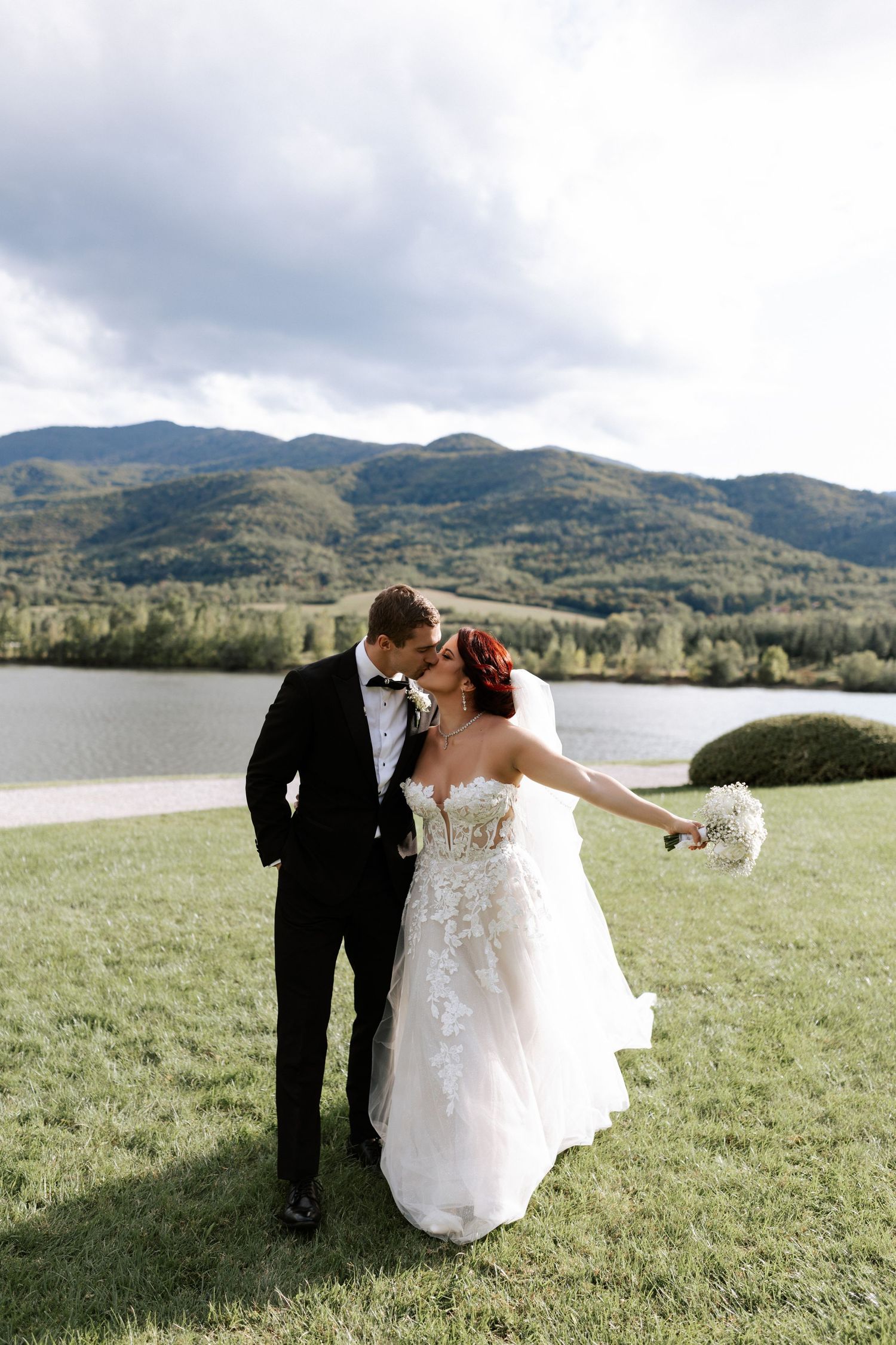 Happy couple shares intimate moment during outdoor mountain wedding.