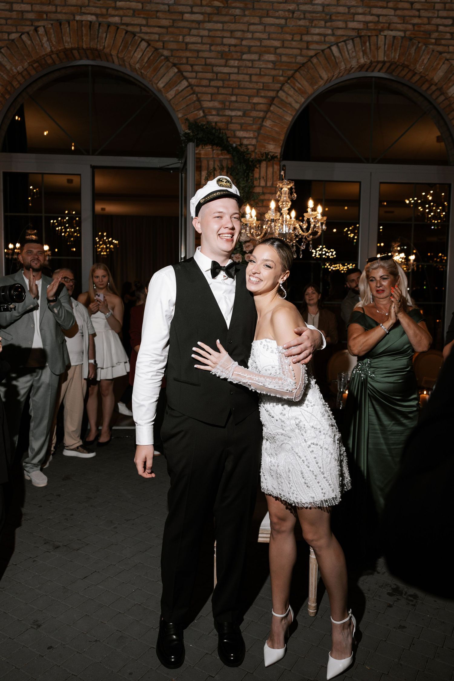 Wedding reception dance floor moments with guests celebrating in formal attire.