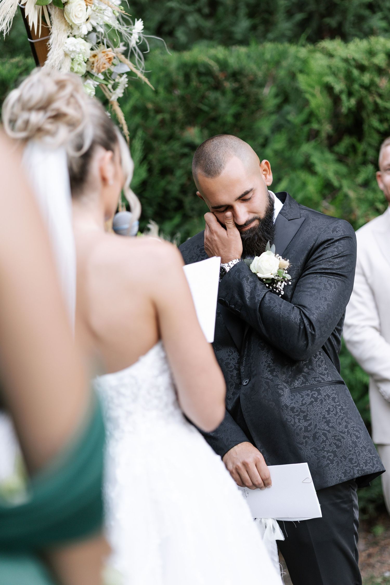 Emotional reactions captured in sequence during a wedding ceremony outdoors with greenery in background.