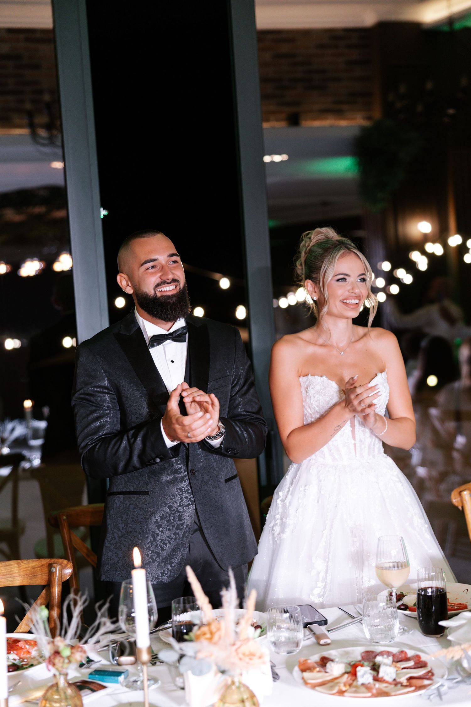 A sequence of candid reception moments shows a bride and groom laughing together at their wedding dinner table.