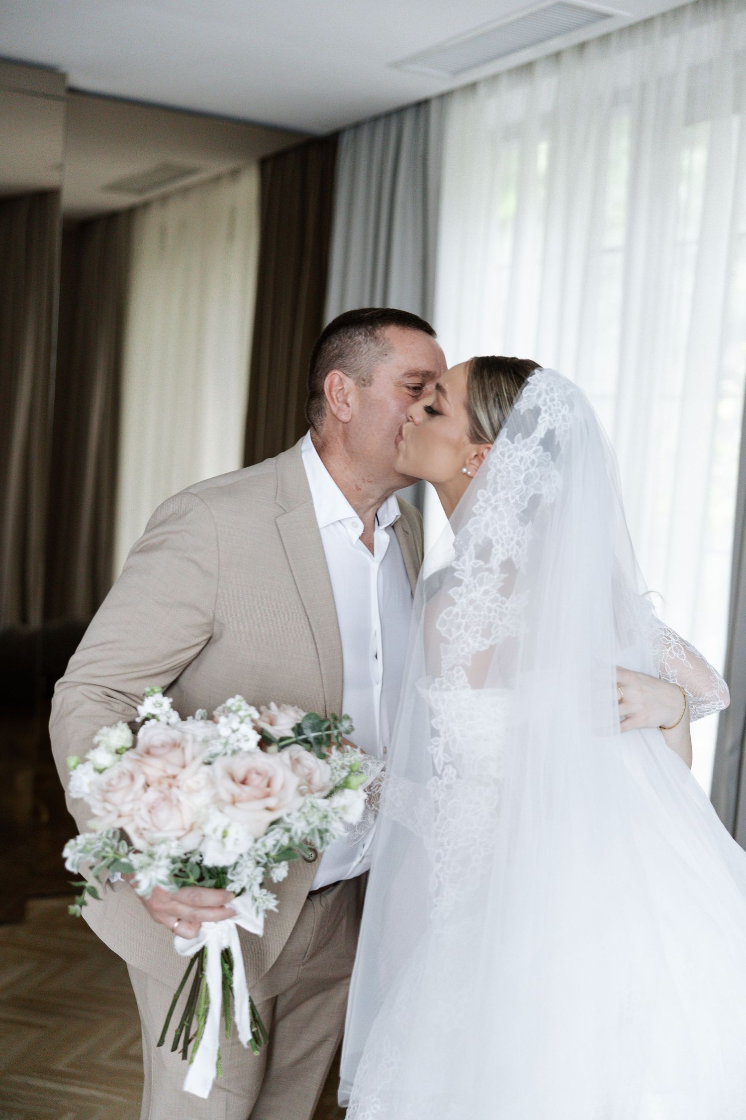 A series of romantic wedding photos showing tender moments between newlyweds in an elegant indoor setting.