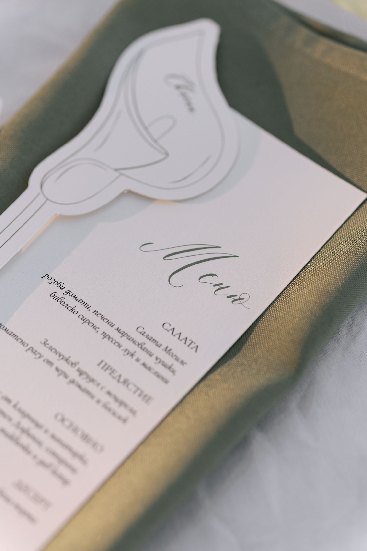 Close-up shots of elegant white business cards with minimalist design and calligraphy text shown from different angles.