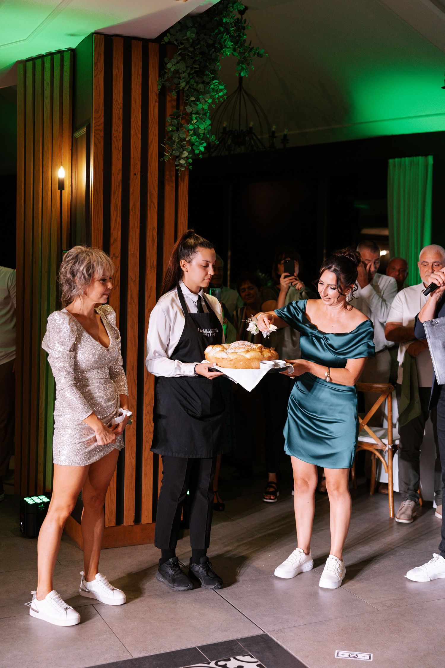 A sequence of photos shows wedding guests playing limbo under a bar in a green-lit reception venue.