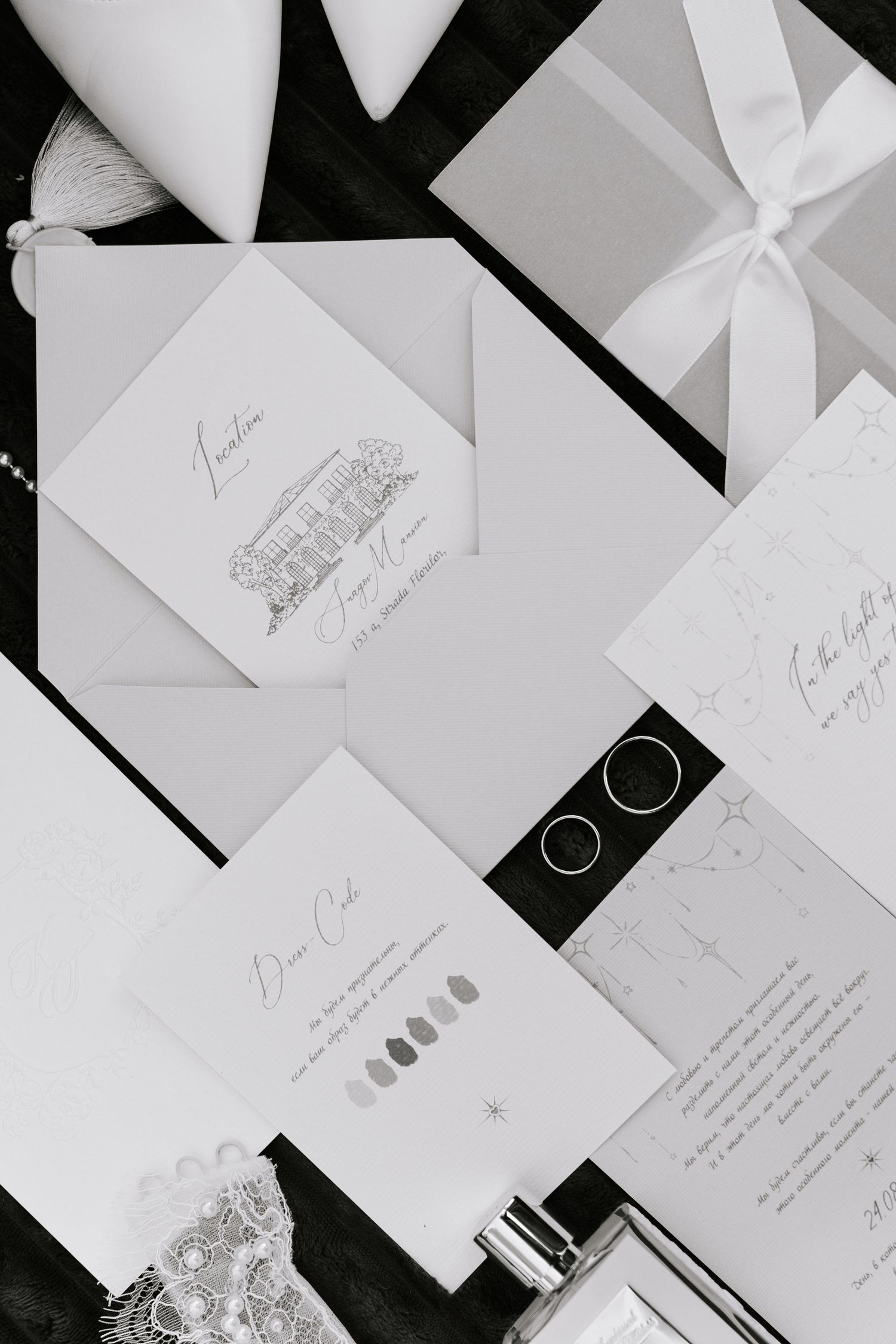 Elegant wedding stationery collection in white featuring invitation cards, envelopes and gift boxes with ribbon details.