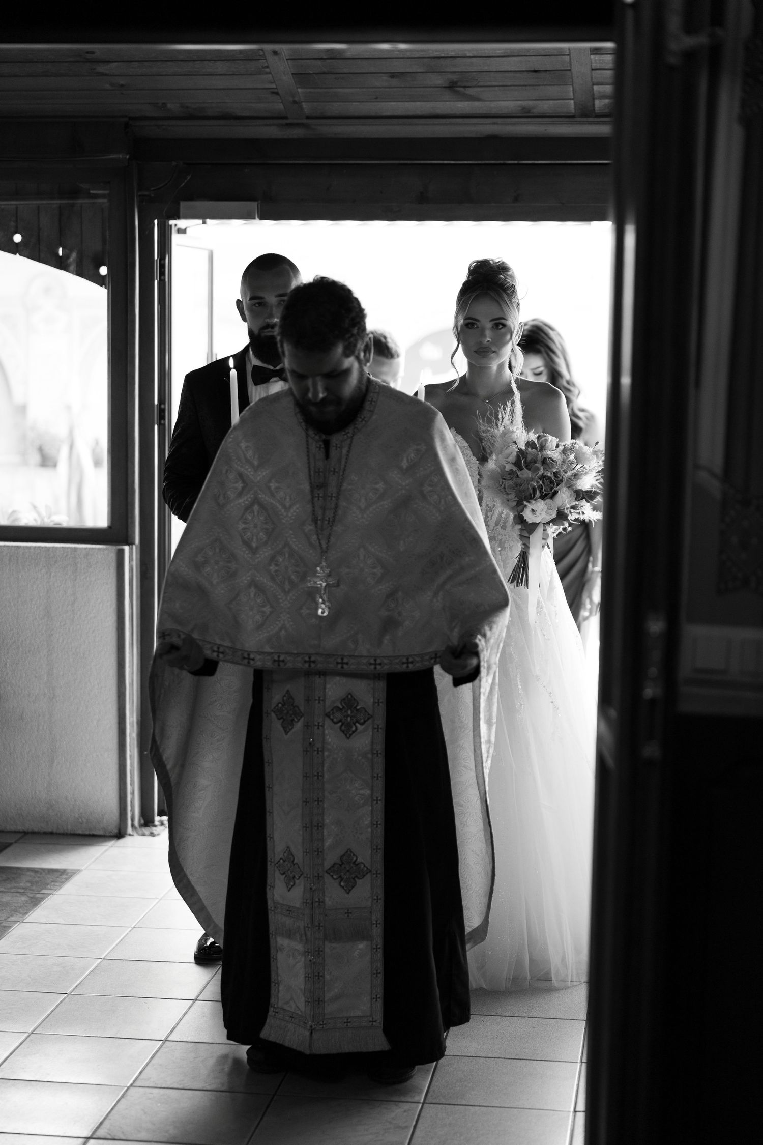 A series of black and white photographs showing religious clergy in traditional robes during a formal ceremony.