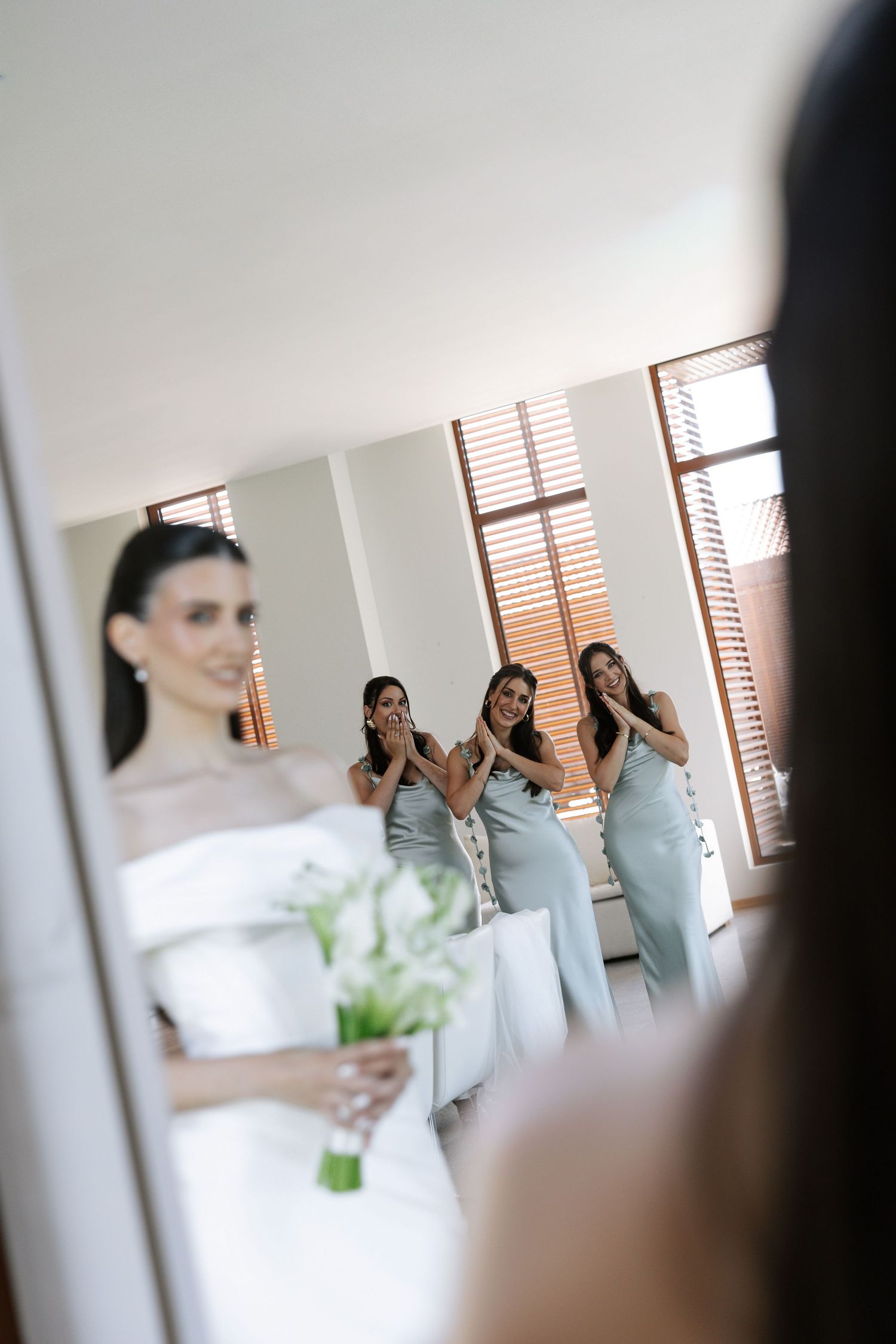 A series of candid shots showing people getting ready in a bright room with wooden window blinds in the background.