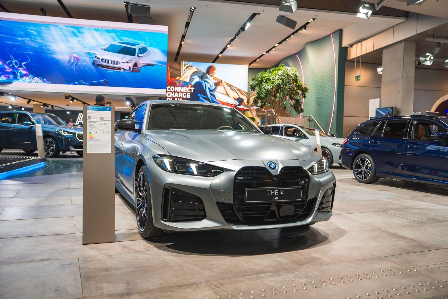 Row of new BMW luxury vehicles showcased in a contemporary dealership showroom.