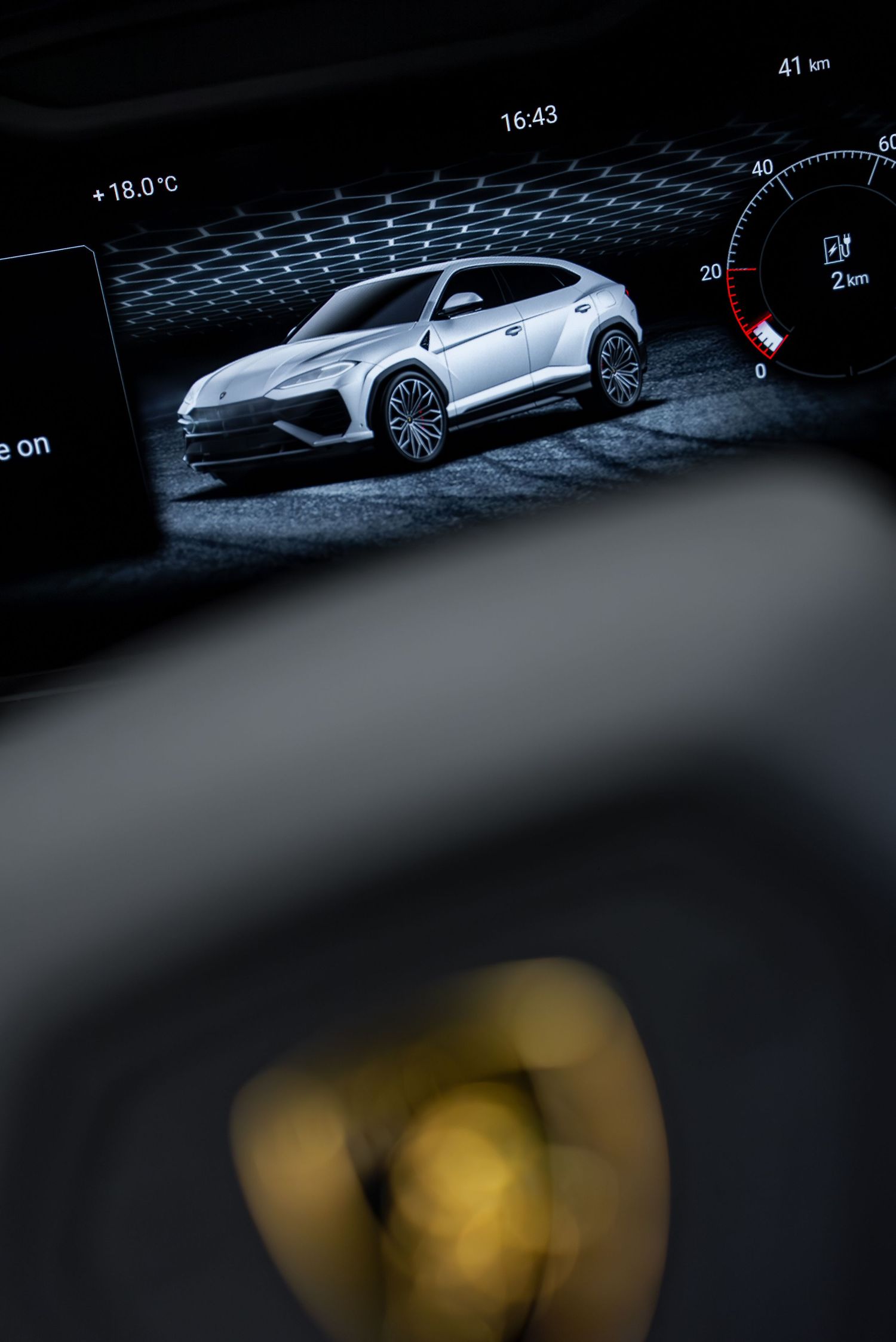 Digital display showing vehicle information and navigation interface in dark ambient lighting.