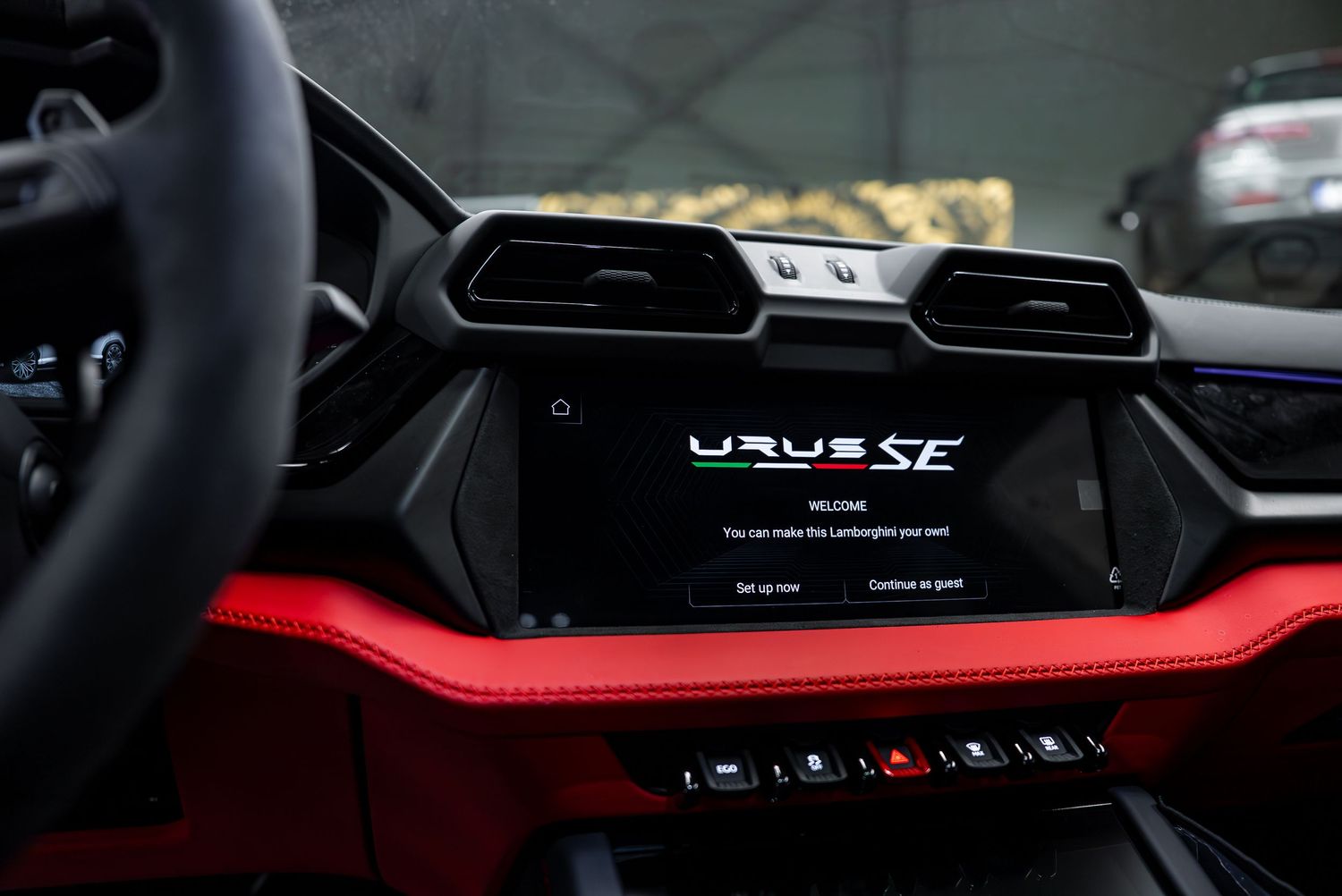 Modern digital dashboard and infotainment display in a Lamborghini cockpit.