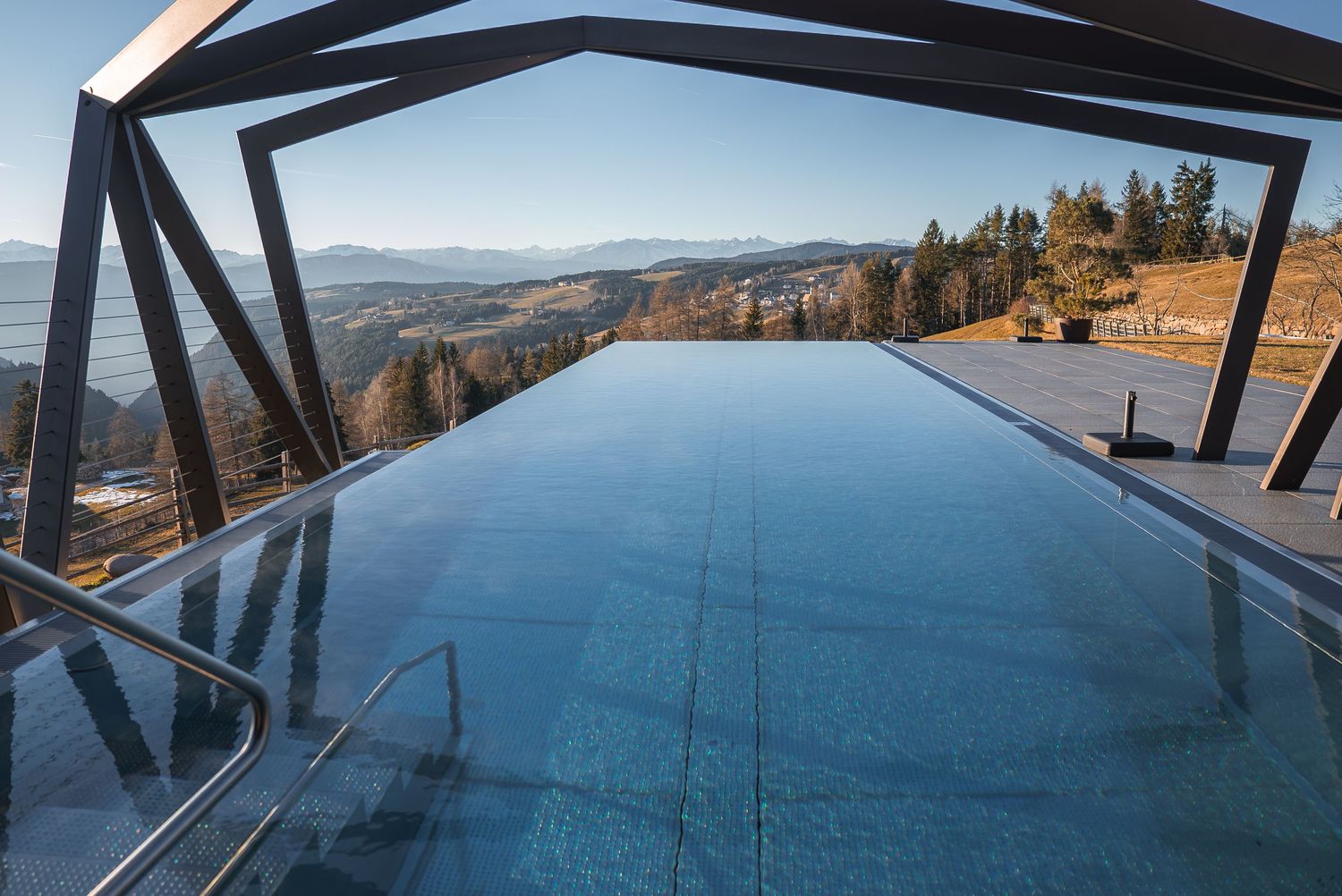 Modern architectural viewing platform overlooking a scenic mountain landscape.