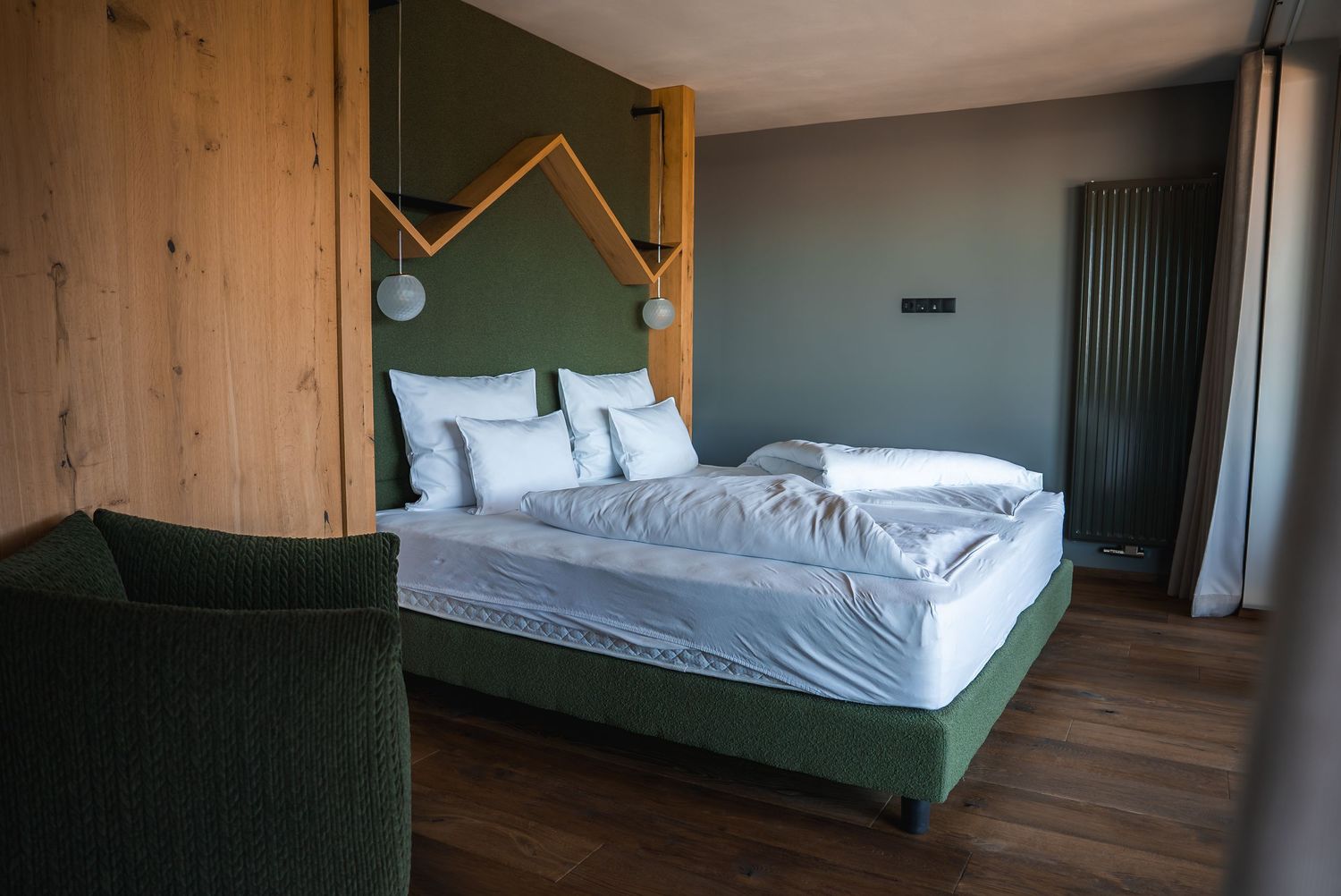 Contemporary bedroom with wooden walls and minimalist green bed design.