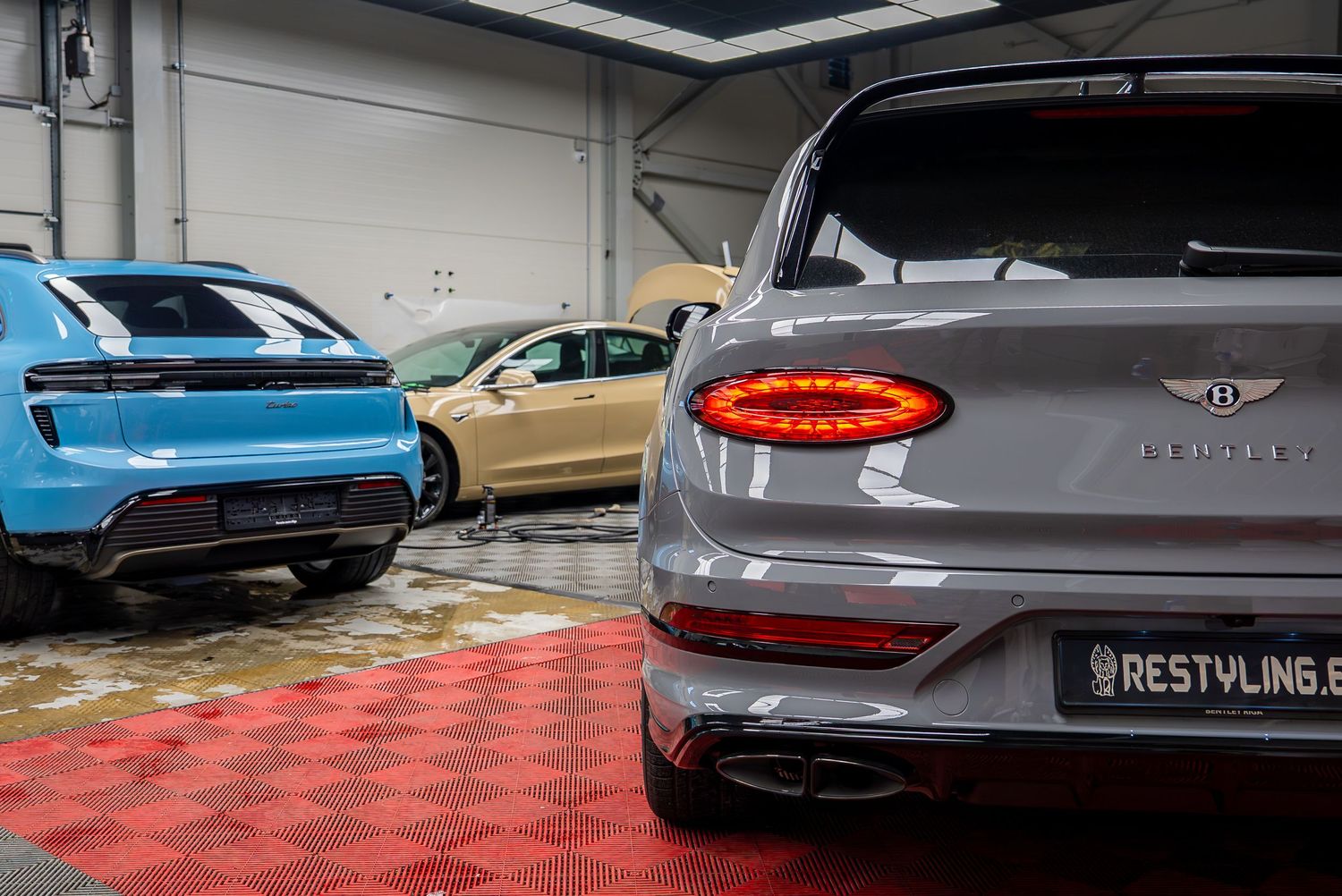 Rear views of premium luxury vehicles showcasing distinctive taillights and badges.