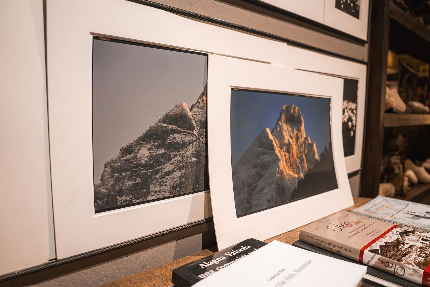 Gallery wall displaying black and white photographs in clean white frames.