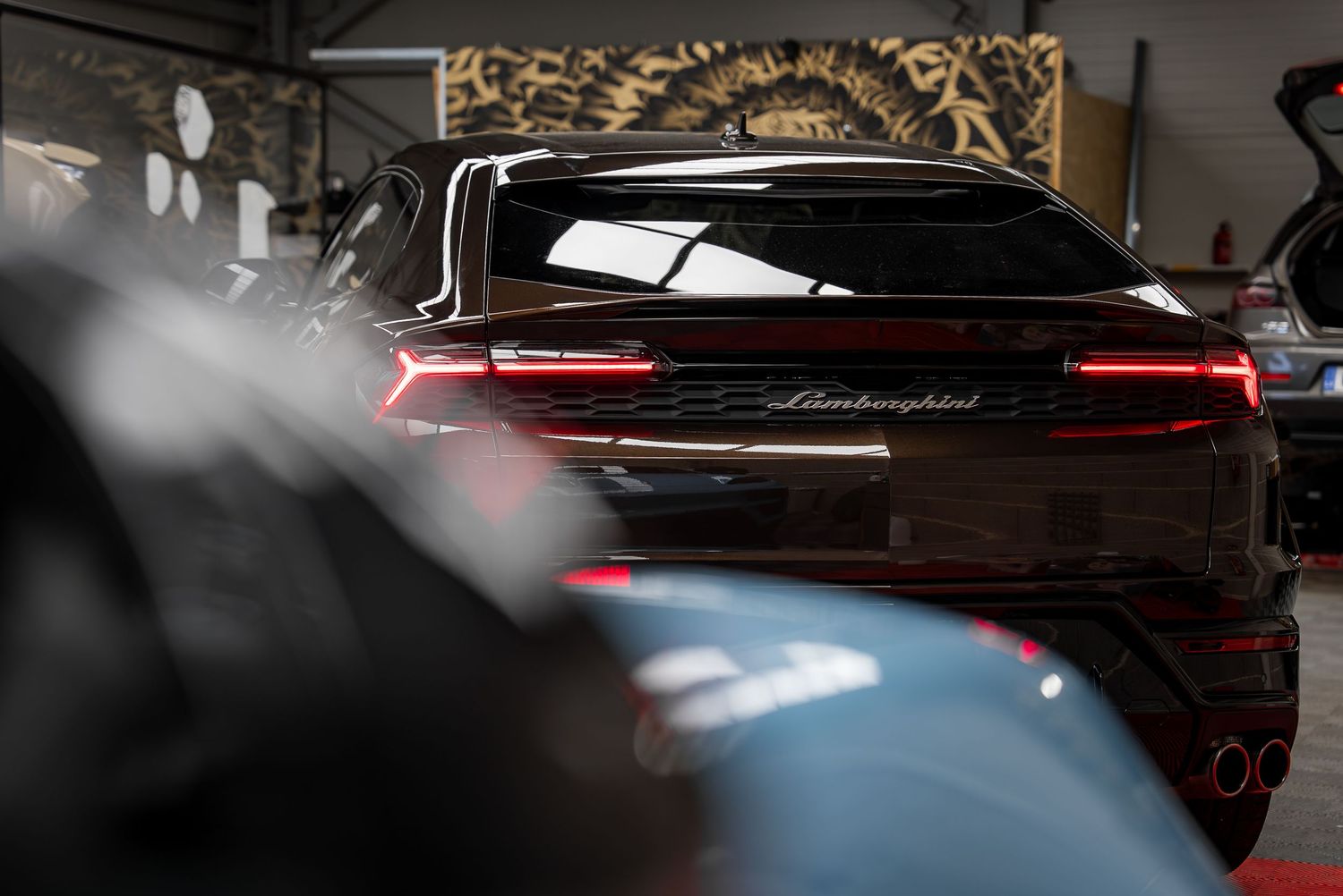 Close-up detail shots of a luxury car's exterior and interior features in dramatic lighting.