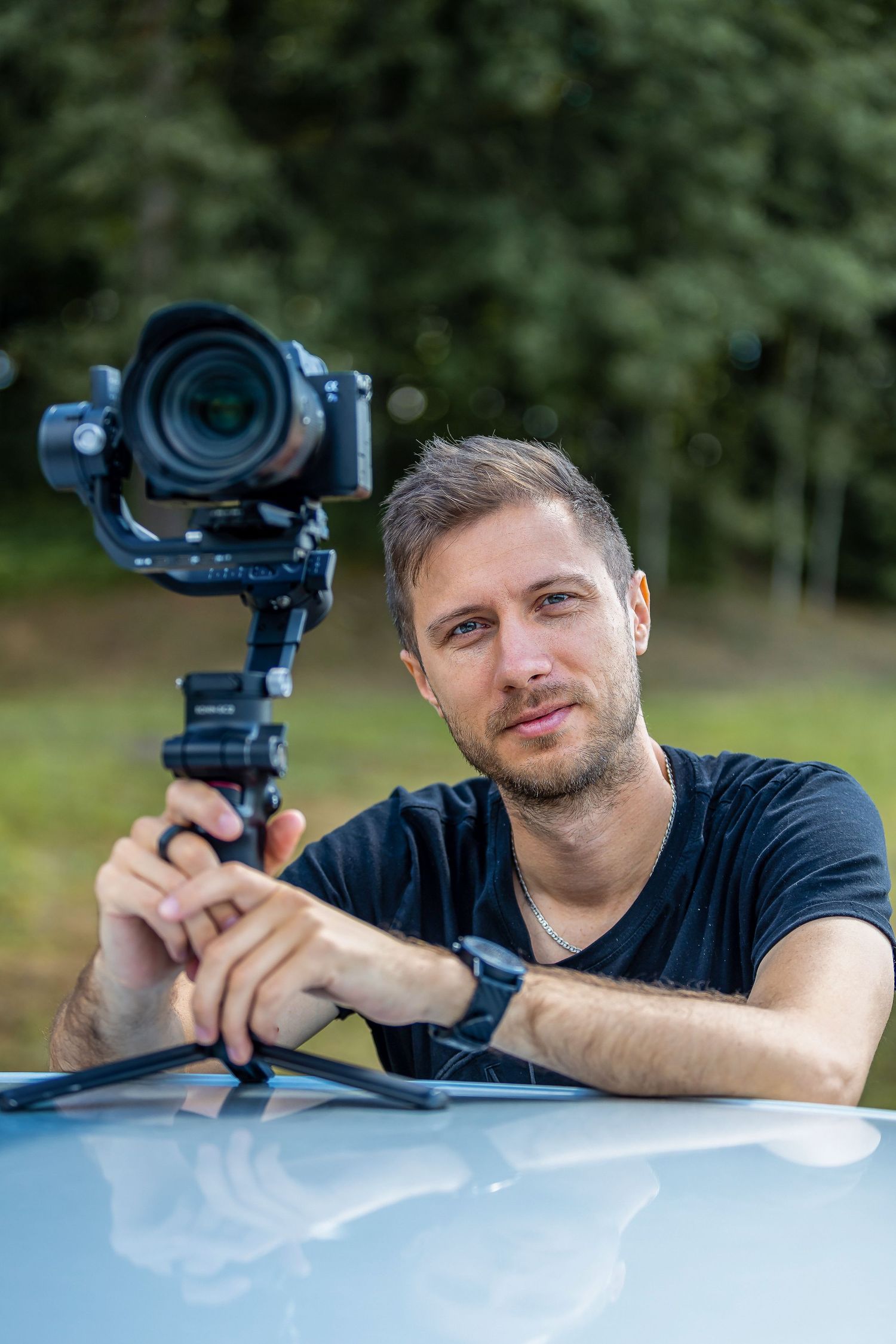 Professional photographer using stabilized camera equipment outdoors.