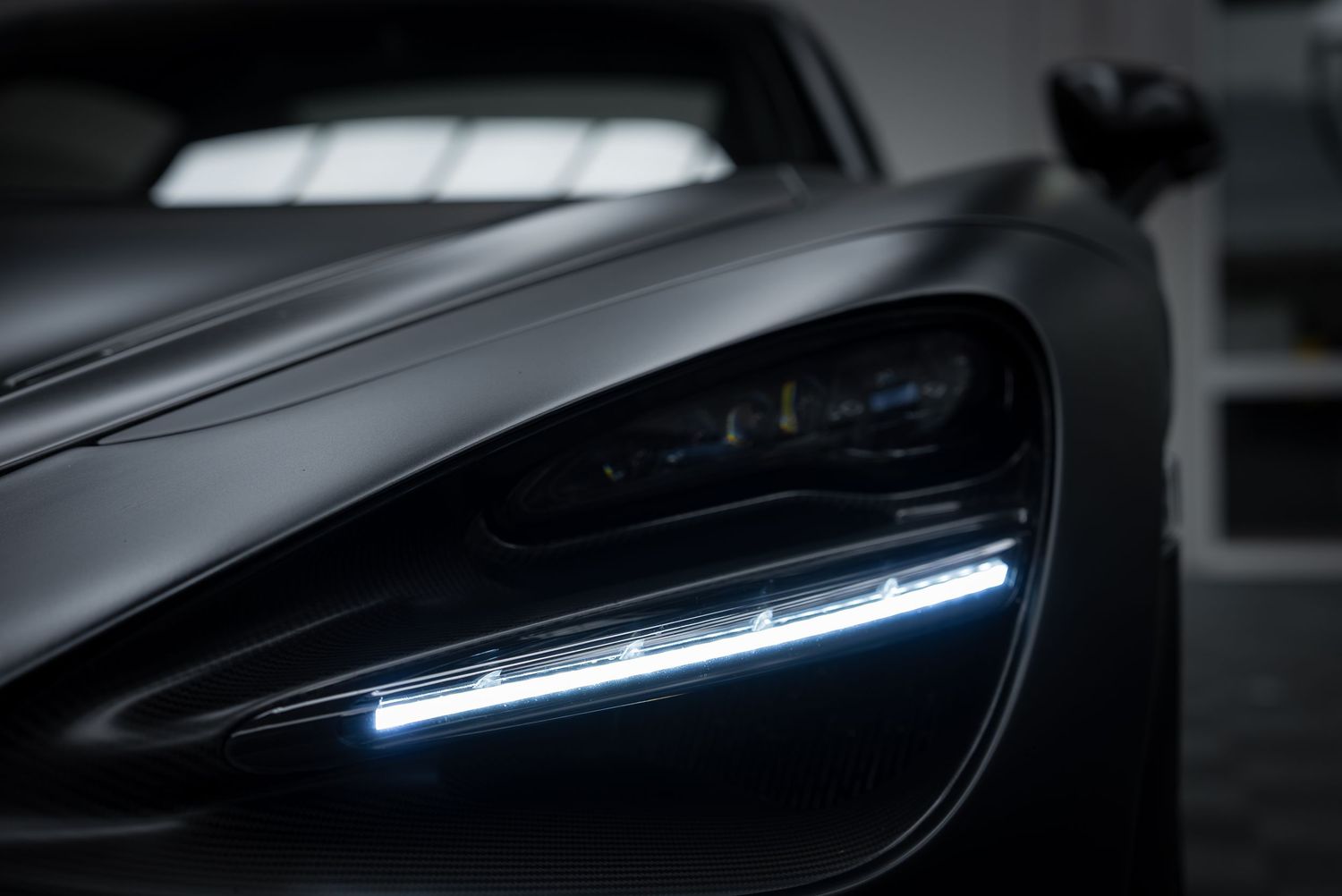 Close-up of sleek modern car headlight design with LED lighting elements.