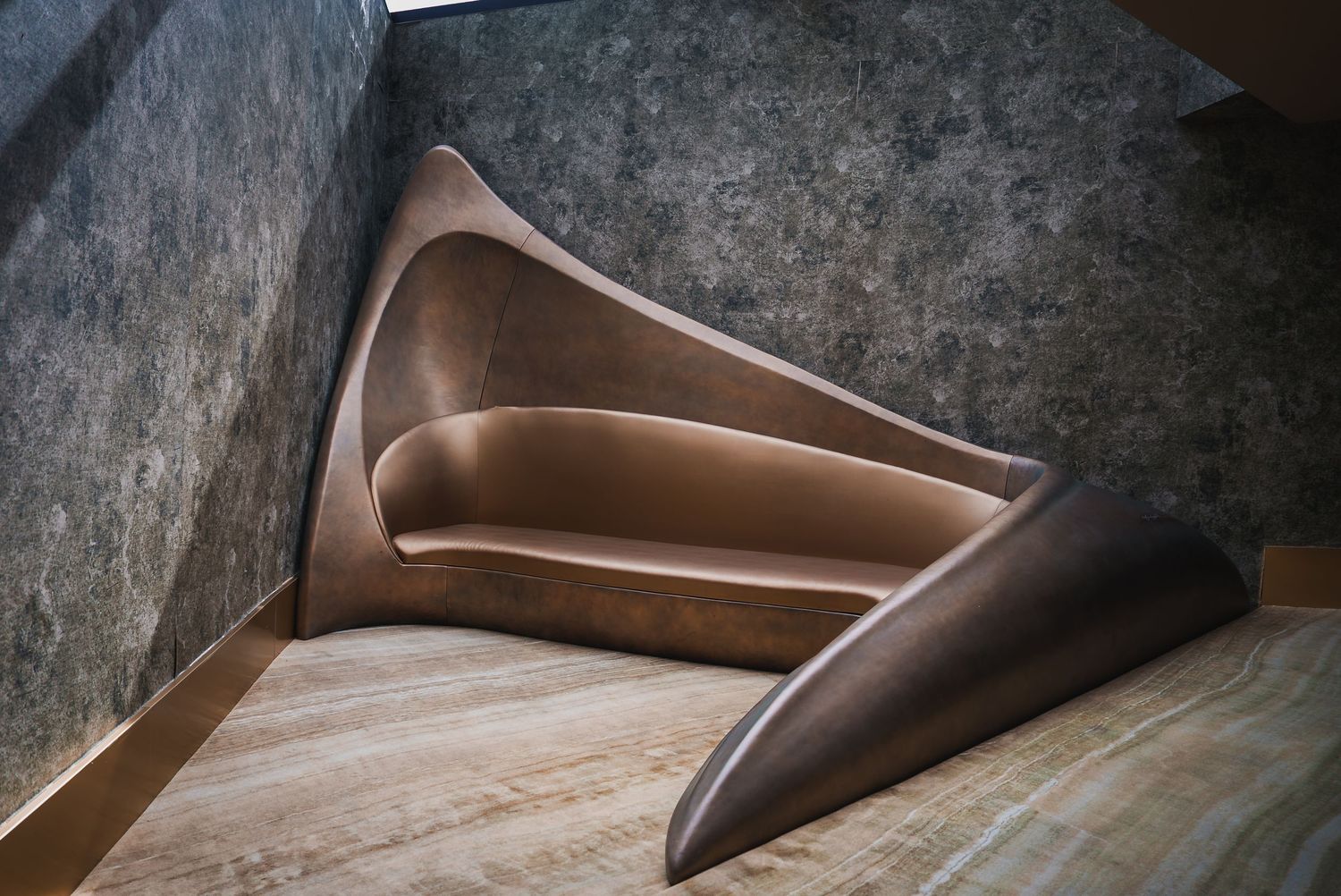 Close-up abstract view of curved brown leather furniture texture.