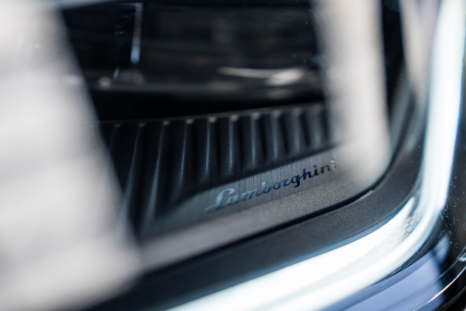 Macro shot of Lamborghini logo detail on vehicle interior trim.