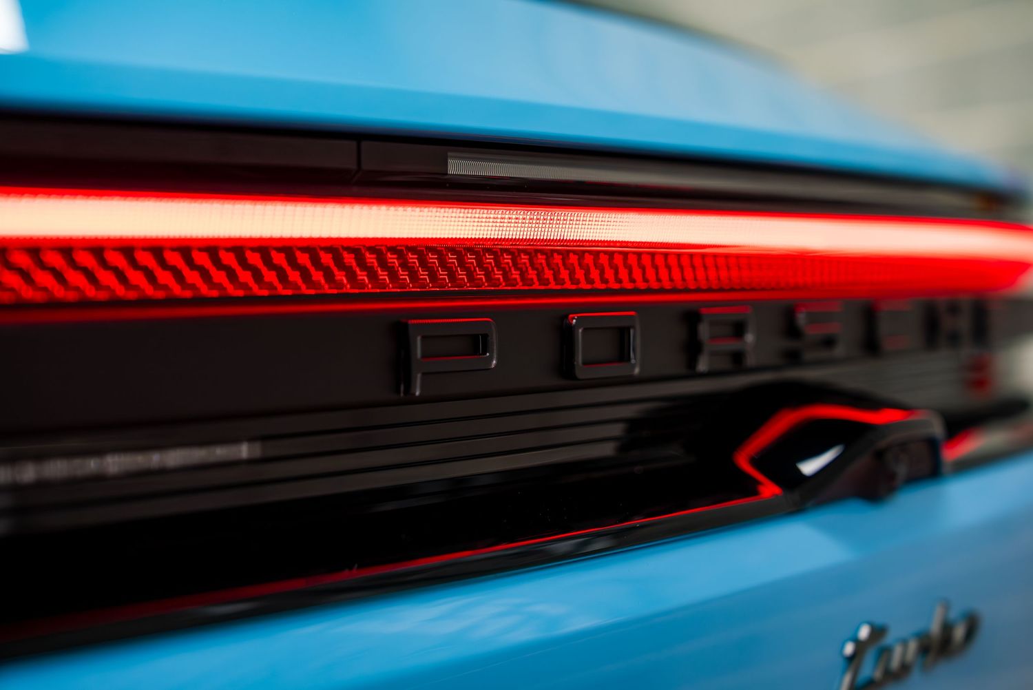 Close-up view of a sleek Lamborghini's LED taillights showing modern lighting design details.