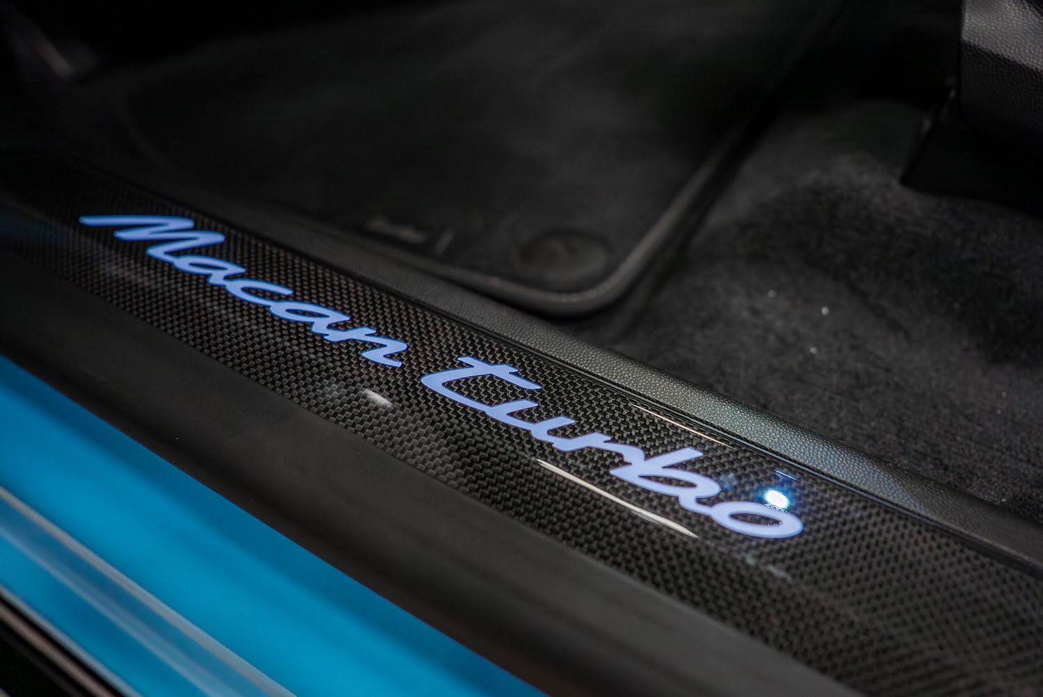 Detail shots of luxury car door sills with illuminated blue lettering.