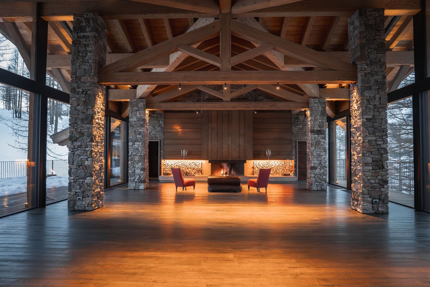 Rustic wooden beam ceiling hallway with stone columns and ambient lighting.