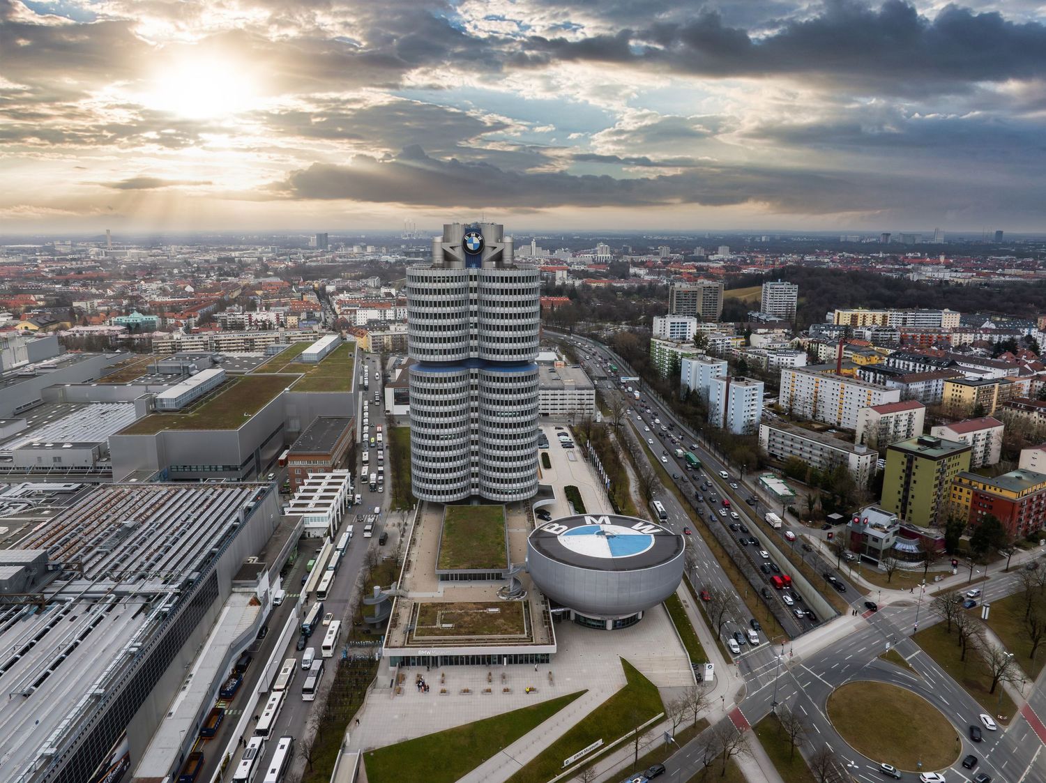 Aerial panorama of a modern city district showing office buildings, parking lots and urban infrastructure.