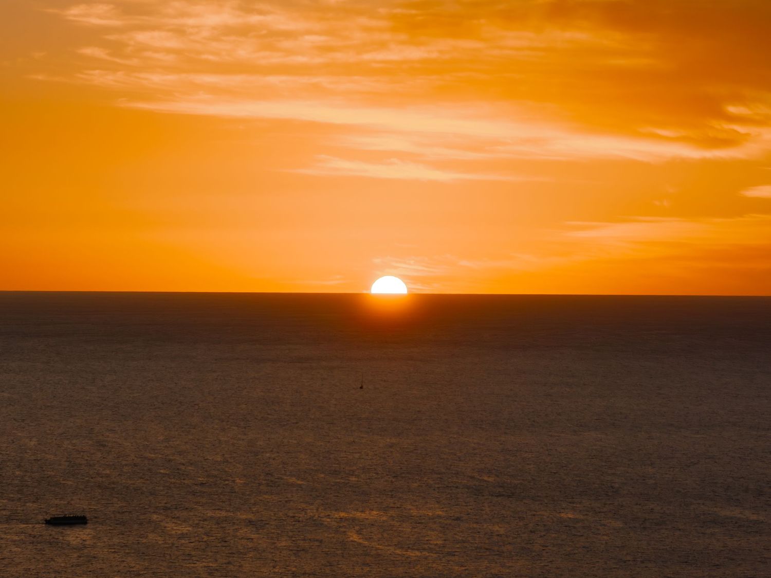 Sequential sunset images showing the sun descending over the horizon with orange sky.