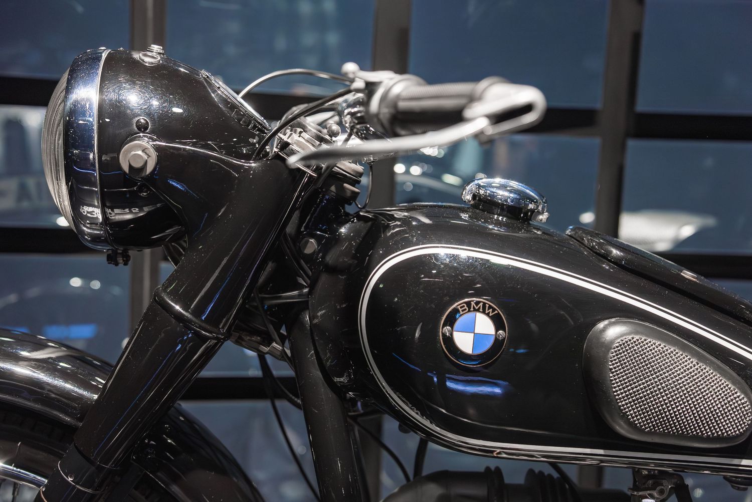 Vintage BMW motorcycles on display showing classic design details and badges.