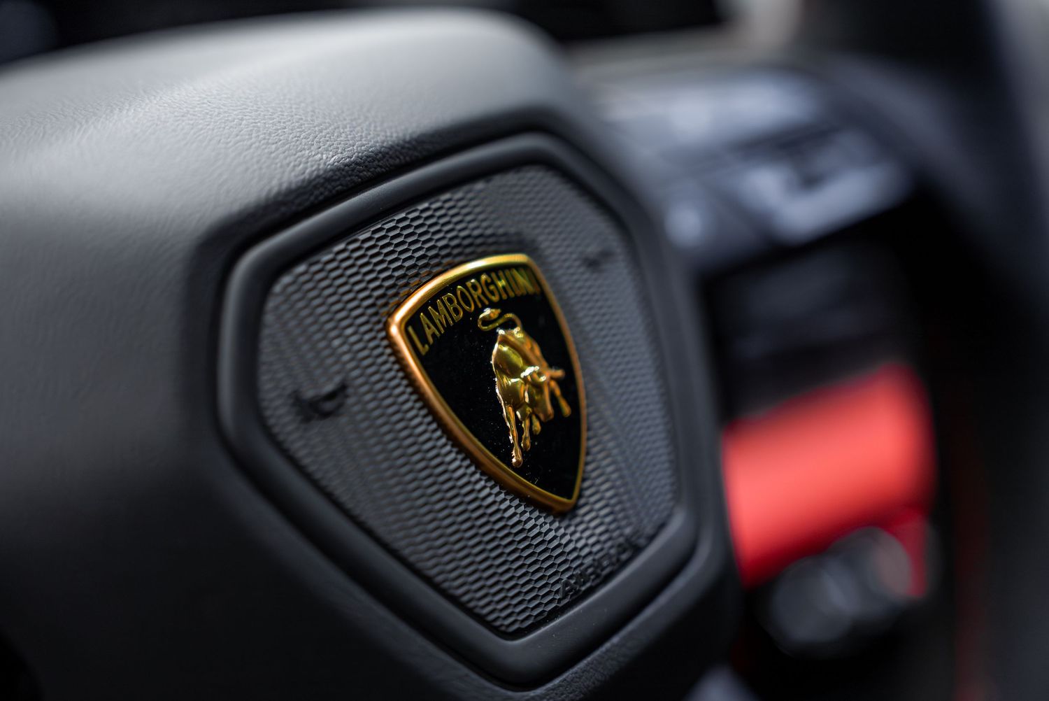 Series of Lamborghini badge and emblem details showing brand identity elements.