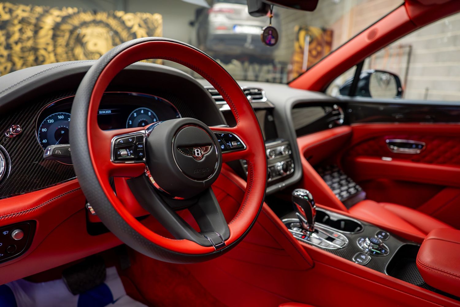 Luxurious red leather interior of a Lamborghini featuring premium dashboard and steering wheel.